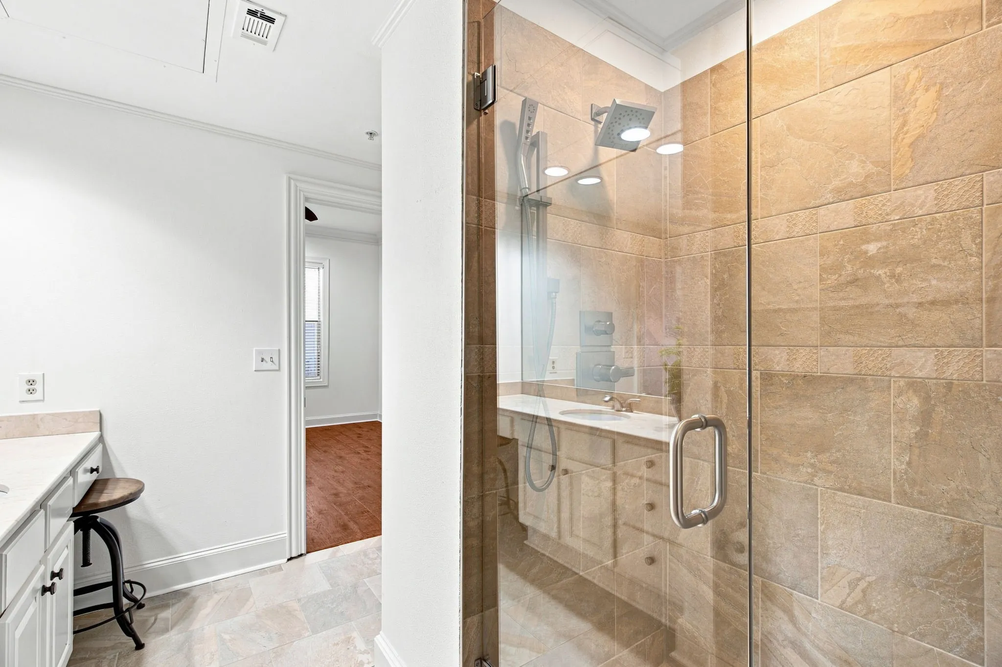 Walk-in shower with full glass enclosure and tile surround