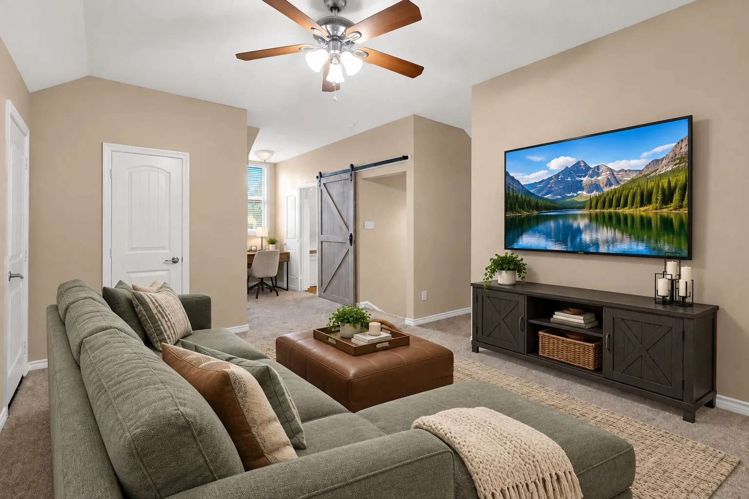 Vaulted ceilings, a ceiling fan, and a rustic barn door entry