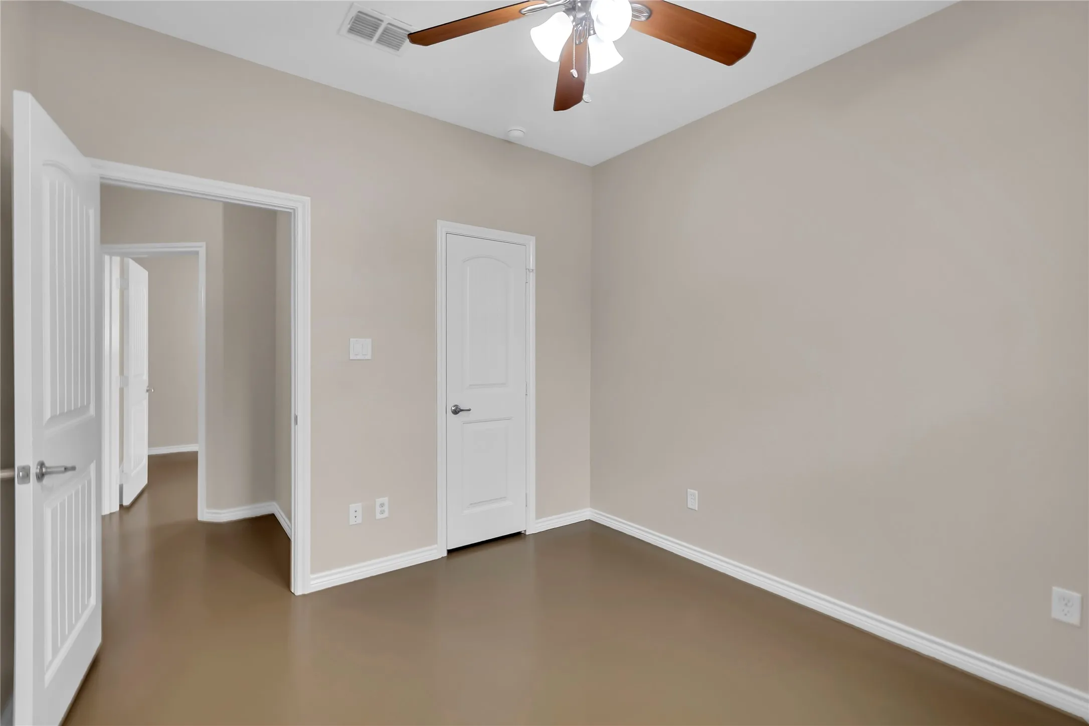 Recessed lighting fixture, light wood-finish ceiling fan with integrated lighting, wood-finish flooring, and white trim throughout