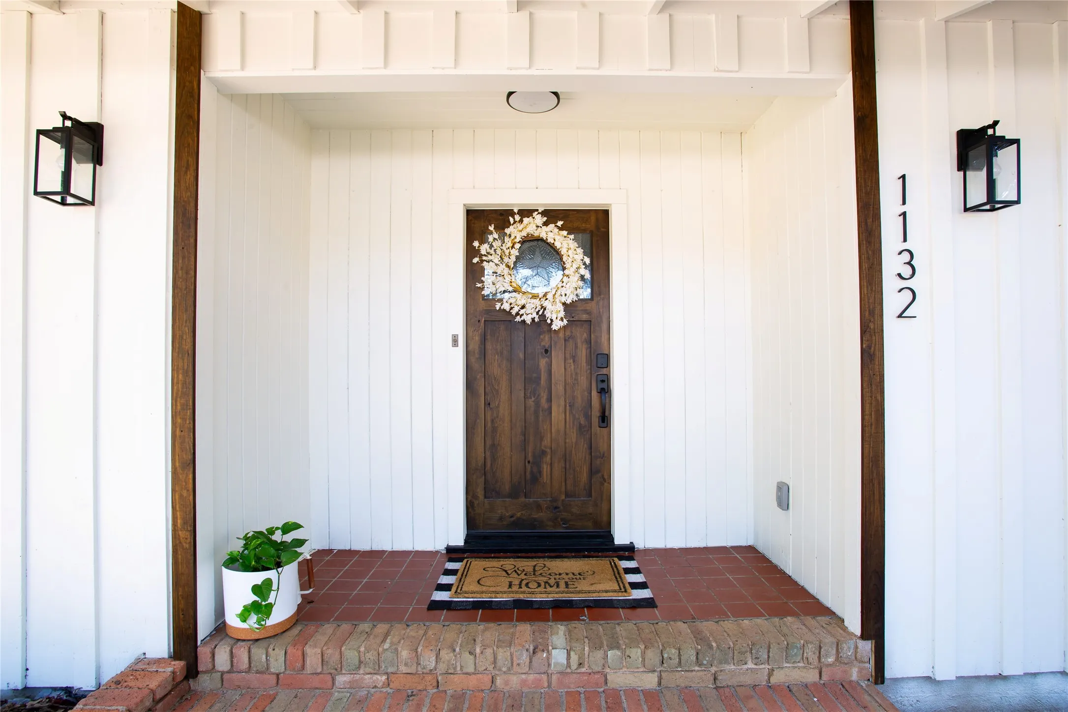 Wood-paneled entry door with circular window detail