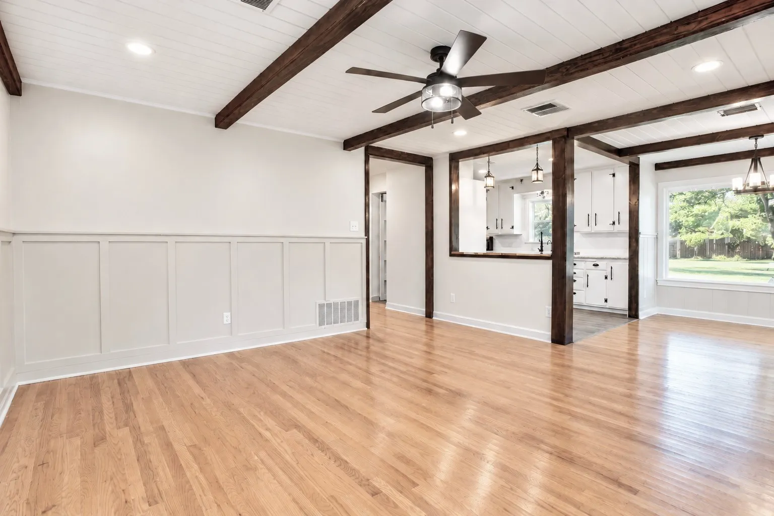 Living room with exposed wooden beams and wood floor