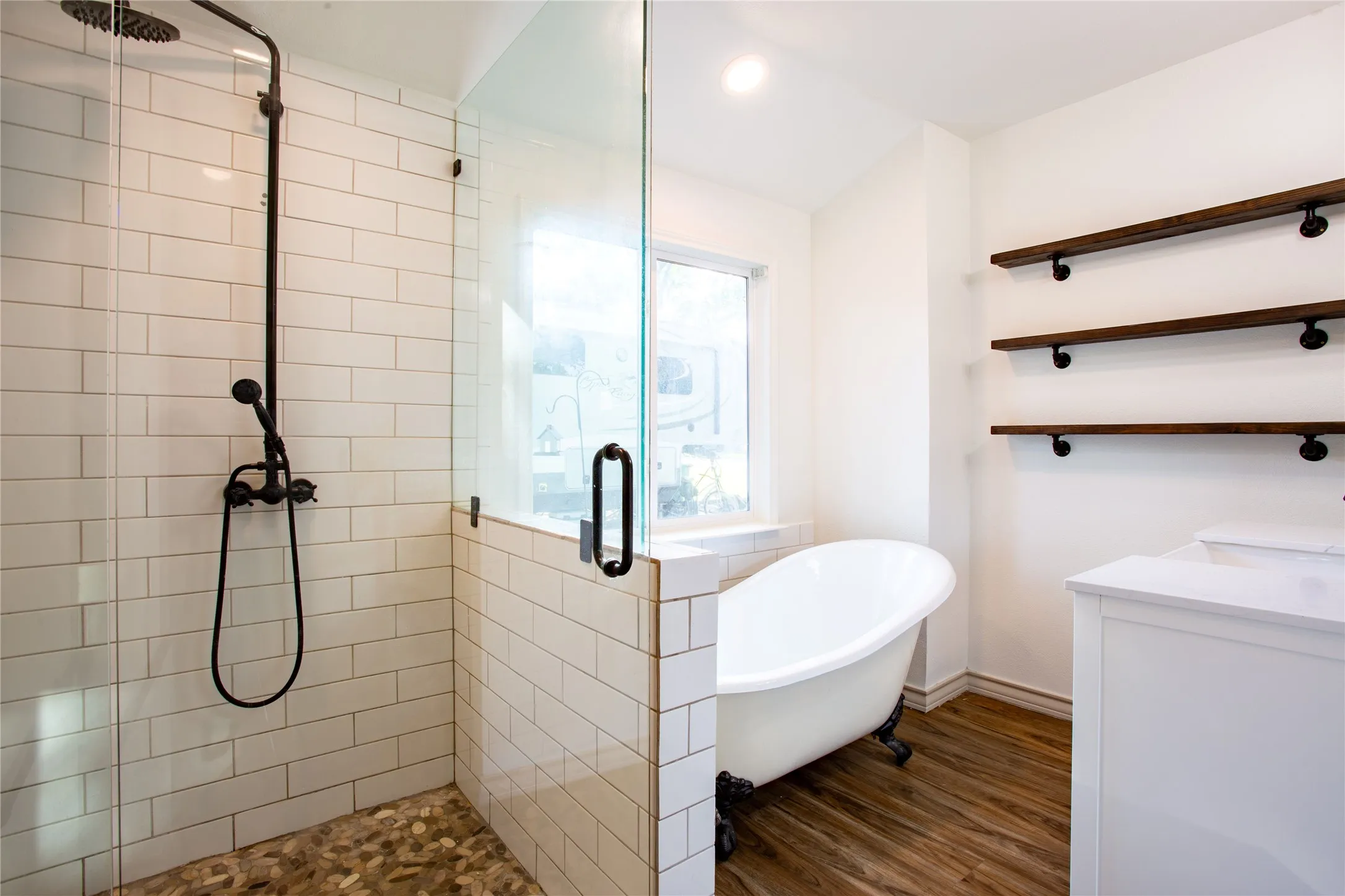 Glass-enclosed shower with subway tile