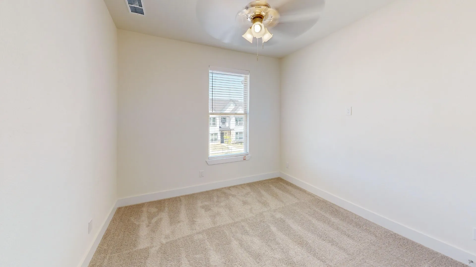 Neutral-toned walls, plush carpet flooring, a window with blinds, and a ceiling fan