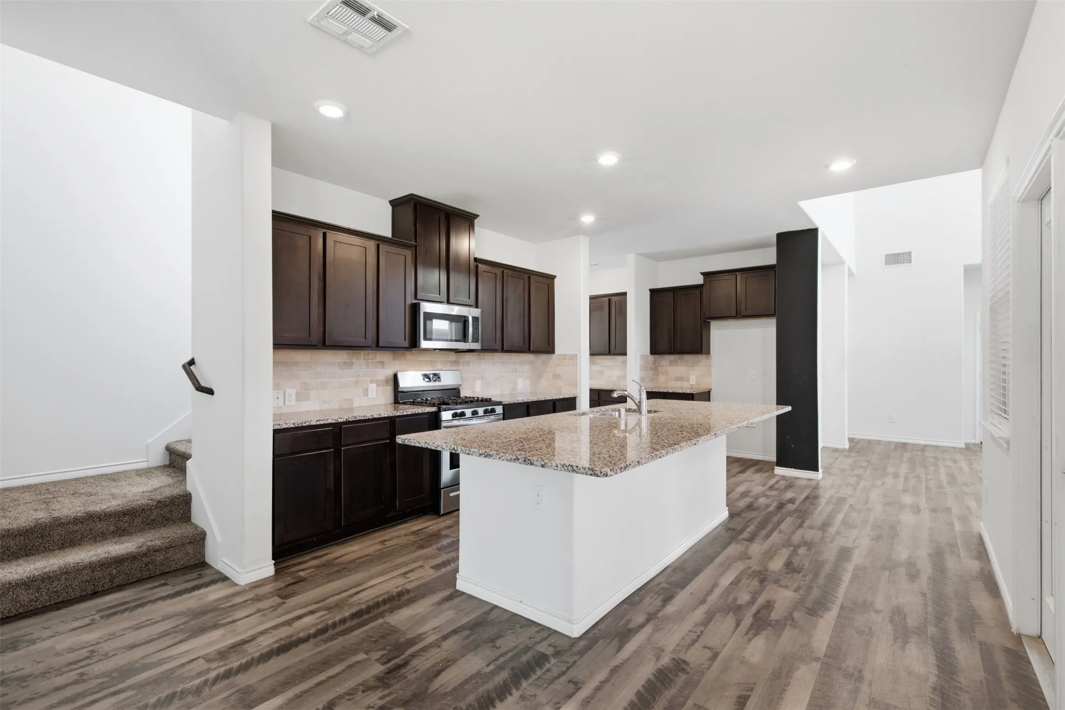 Kitchen with oversized island. Landlord is providing a new refrigerator for Tenant's use.