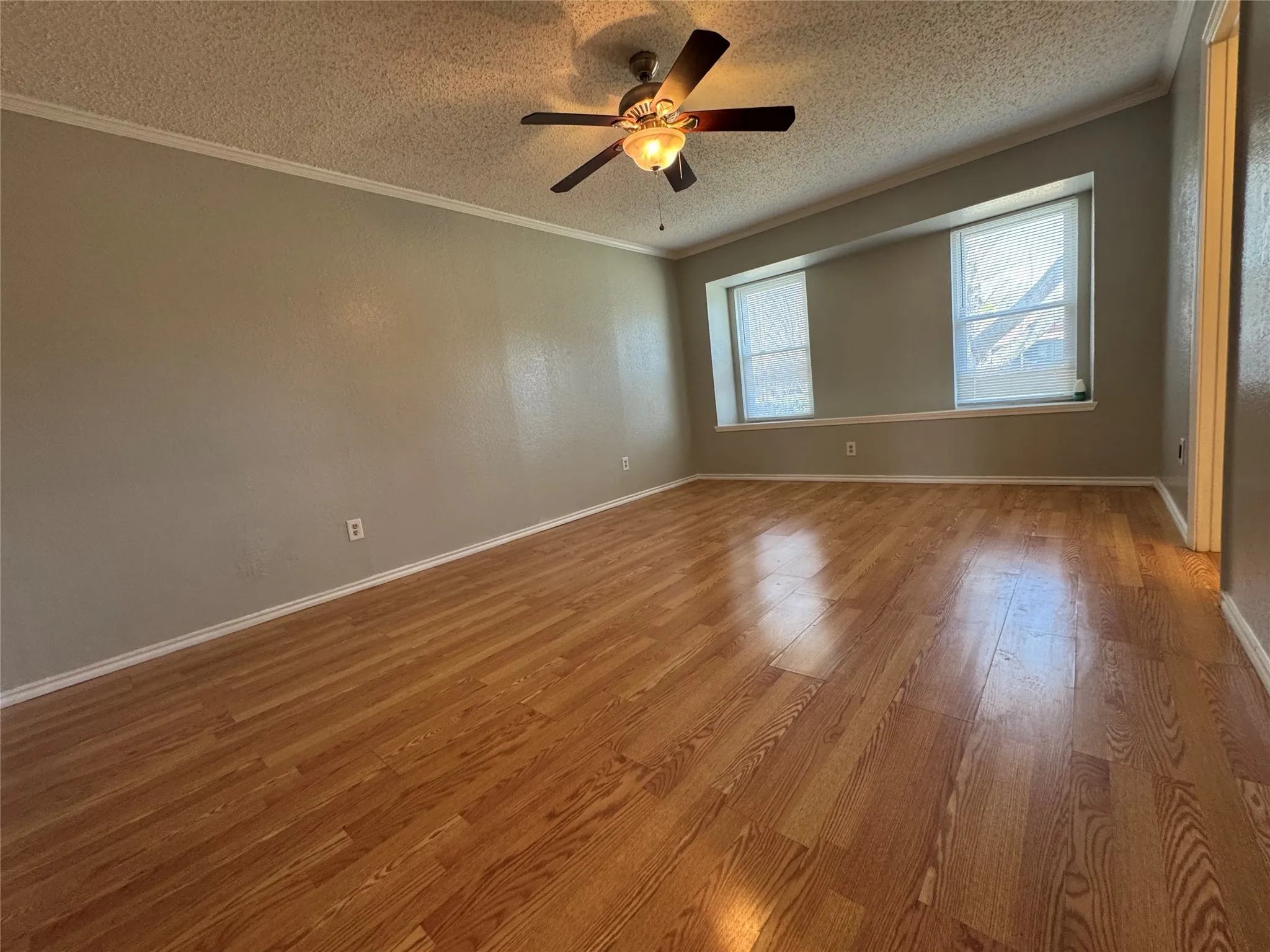 Primary bedroom with bench seat along windows