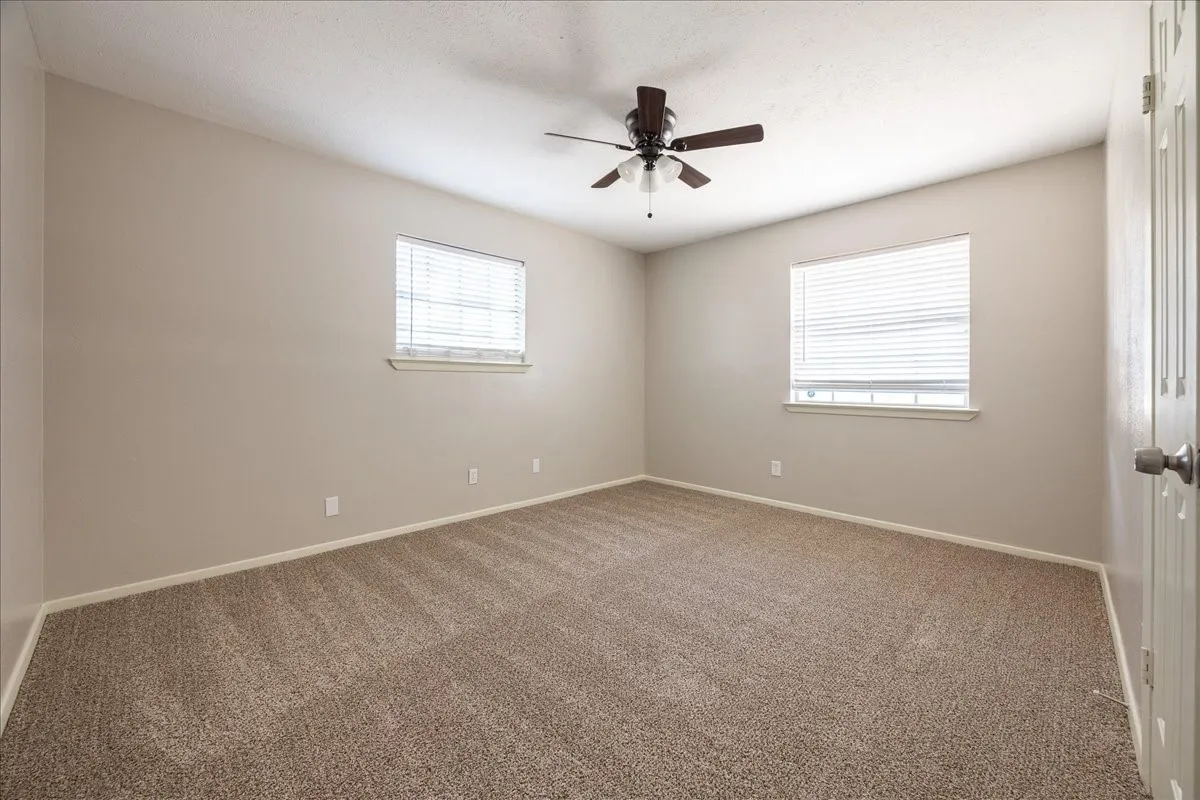 Neutral-toned walls complement plush carpet flooring