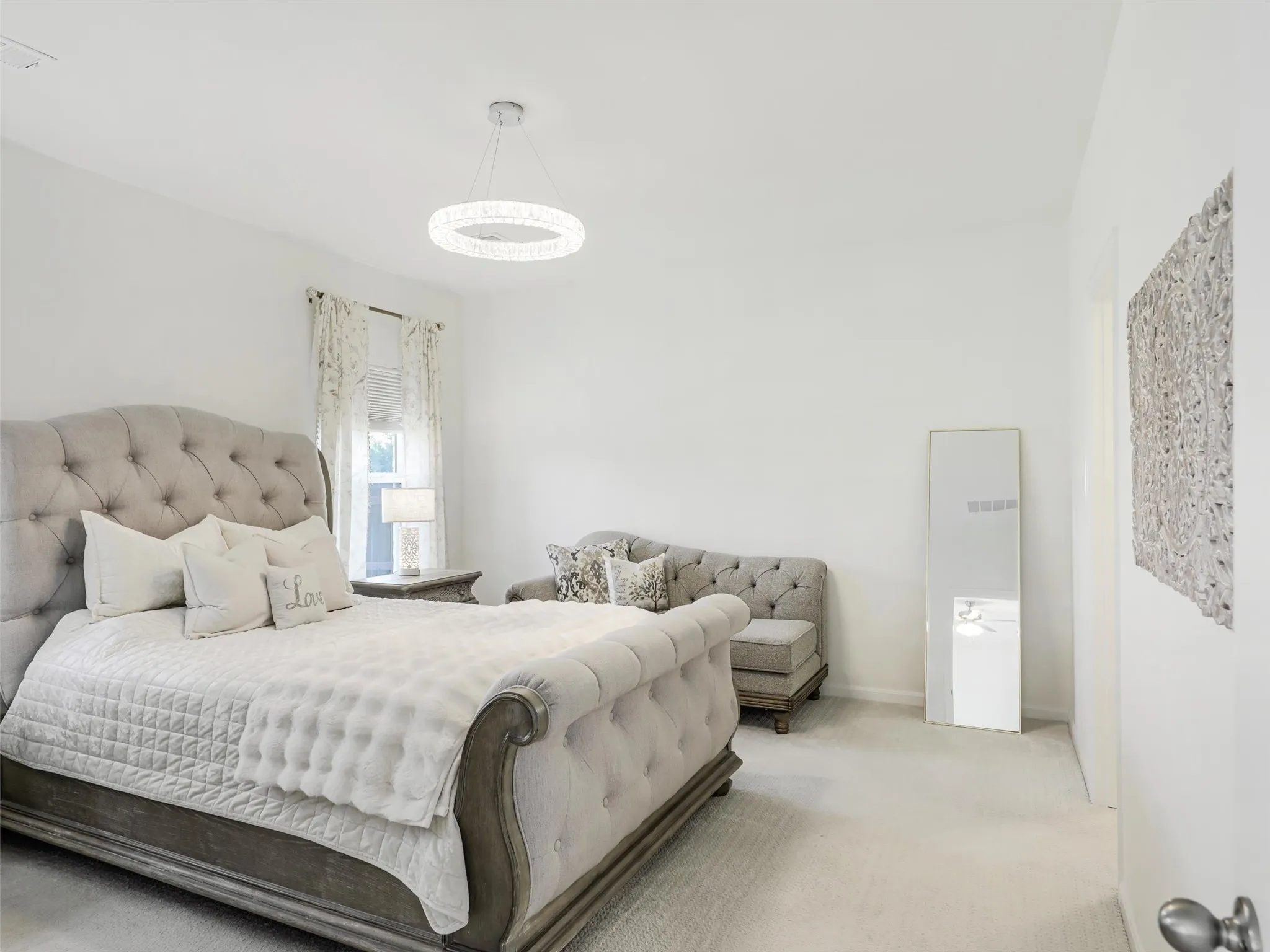 Recessed window with wall-to-wall carpeting, and a modern circular chandelier