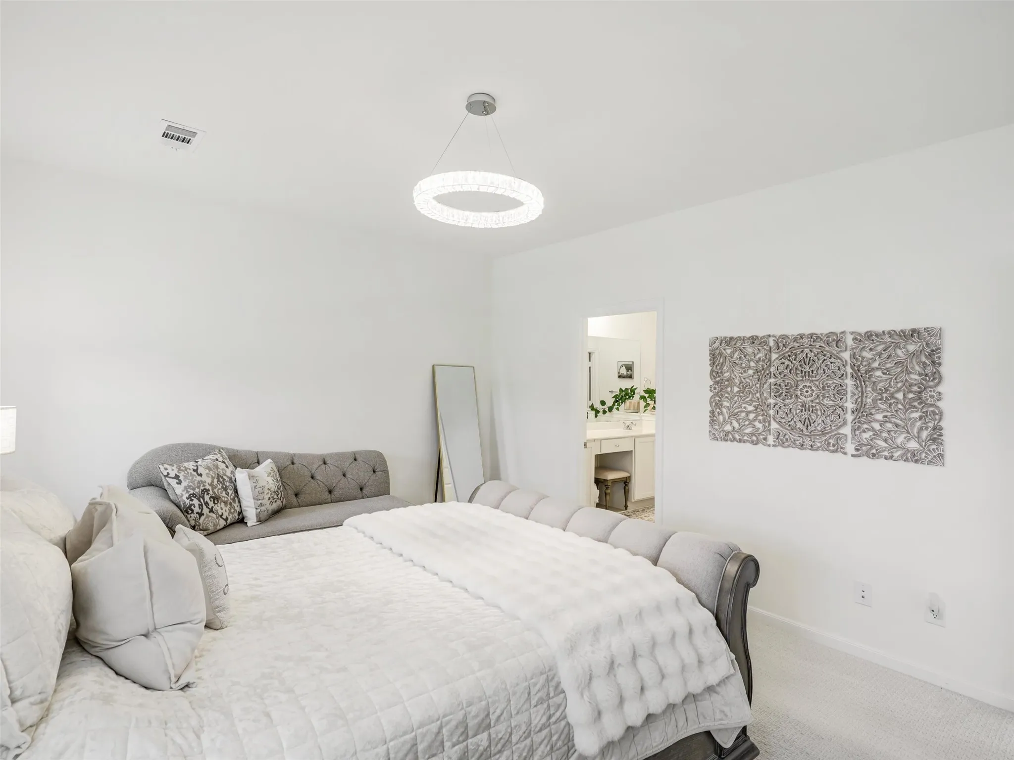 Recessed ceiling lighting, modern circular chandelier, plush carpeting