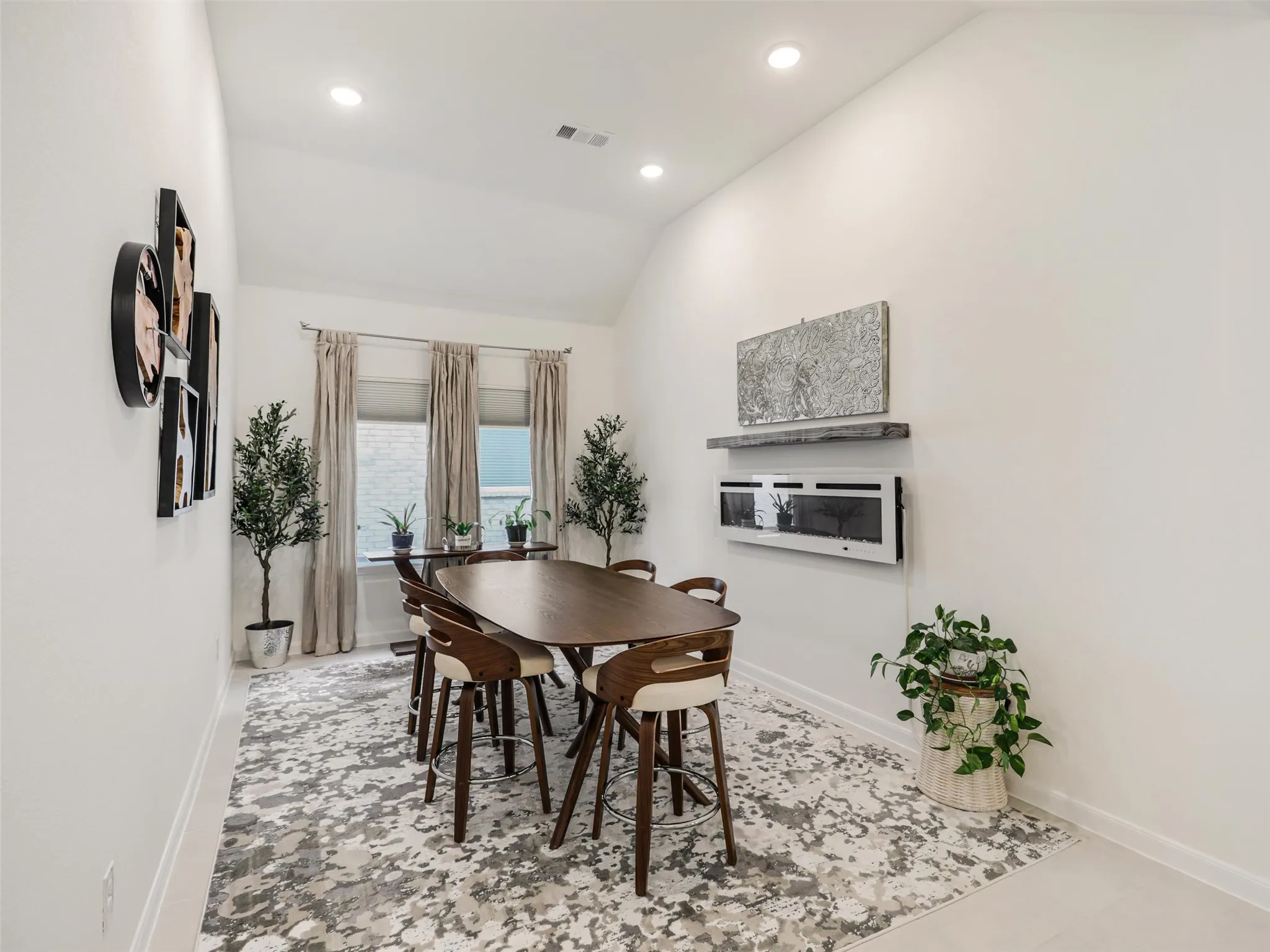 Vaulted ceiling with recessed lighting, large windows
