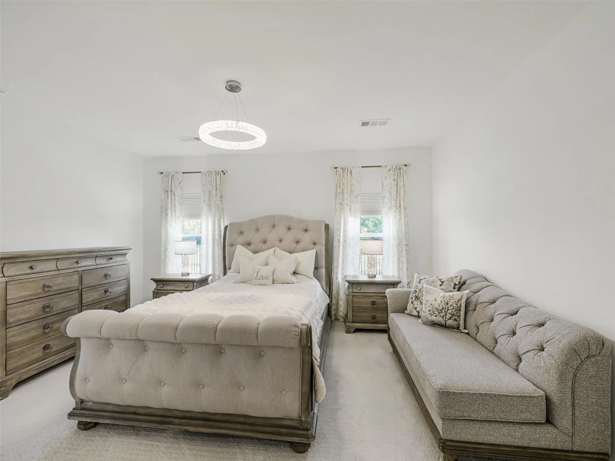 Recessed lighting, light-colored walls, and carpet flooring