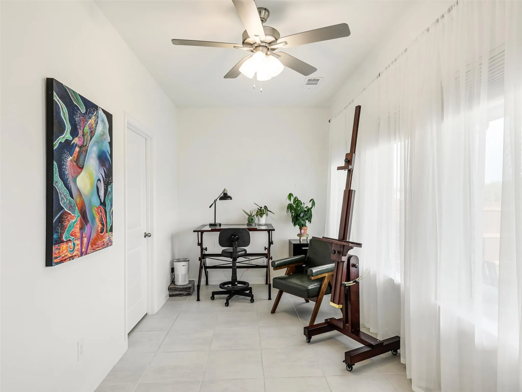 Recessed lighting, ceiling fan, white paneled door, large windows, and tile flooring