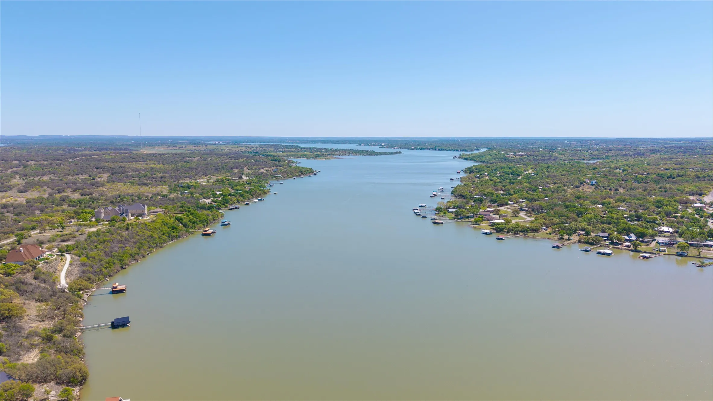 Expansive waterfront with multiple docks and lush, tree-lined shores