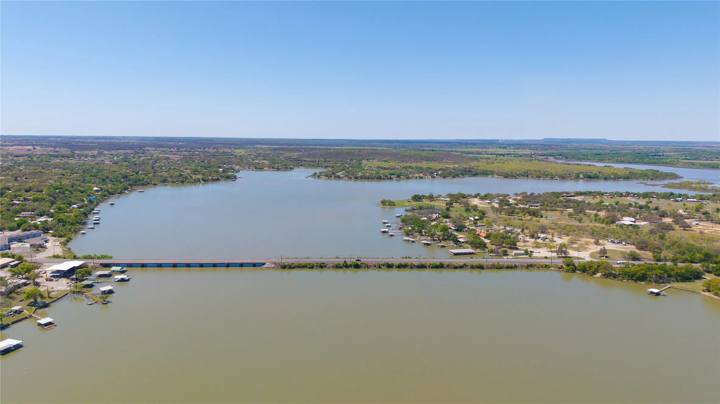 Expansive lake with a connecting bridge and surrounding residential areas