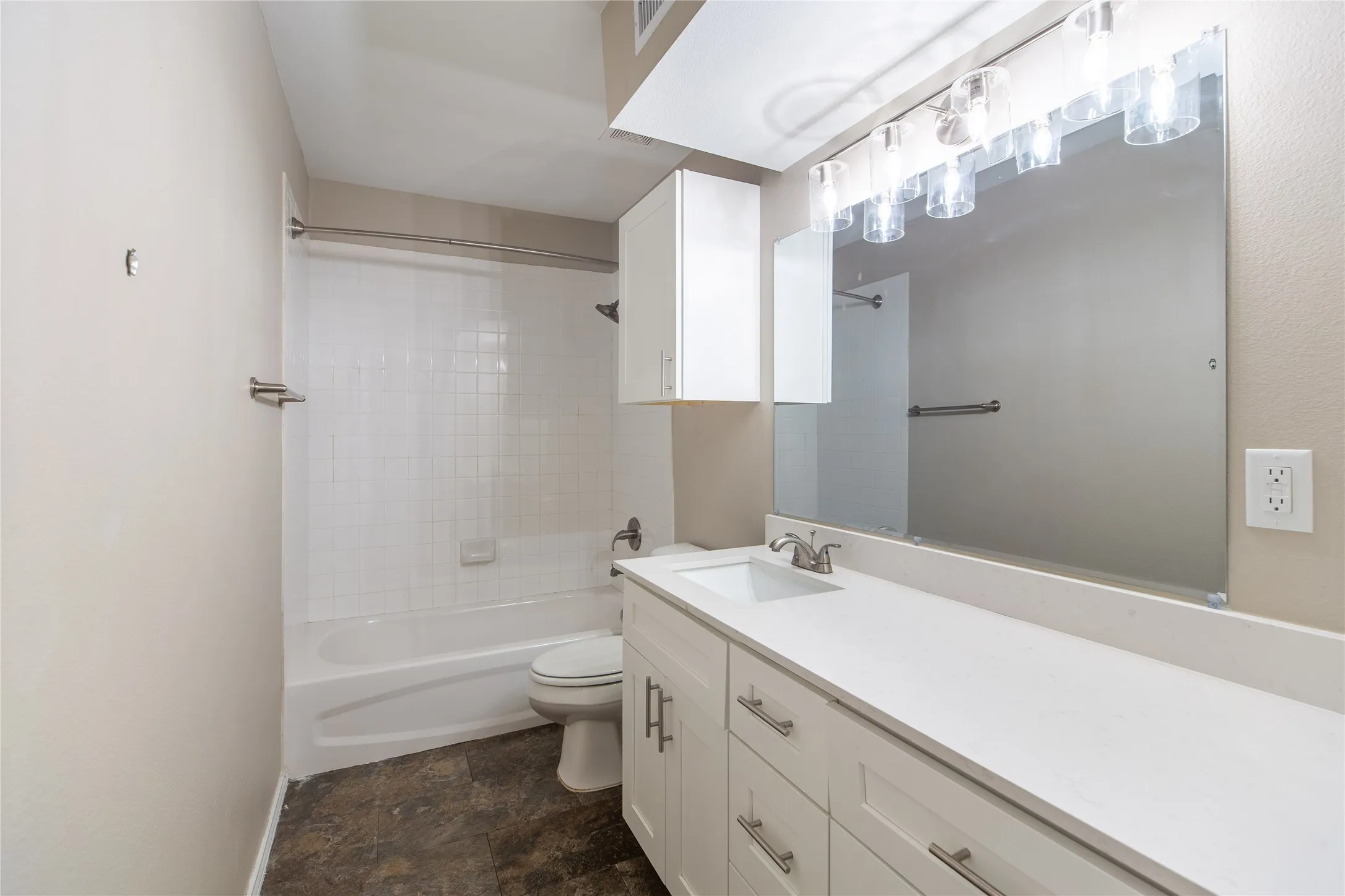 White vanity with shaker-style cabinetry, a white countertop, and a rectangular undermount sink