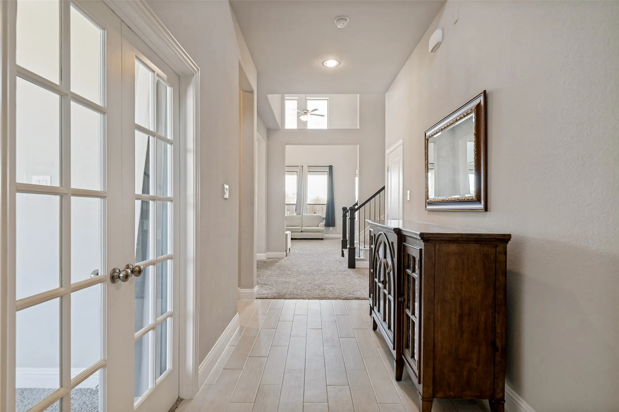 Hallway with wood-finish flooring, recessed lighting, and a built-in console