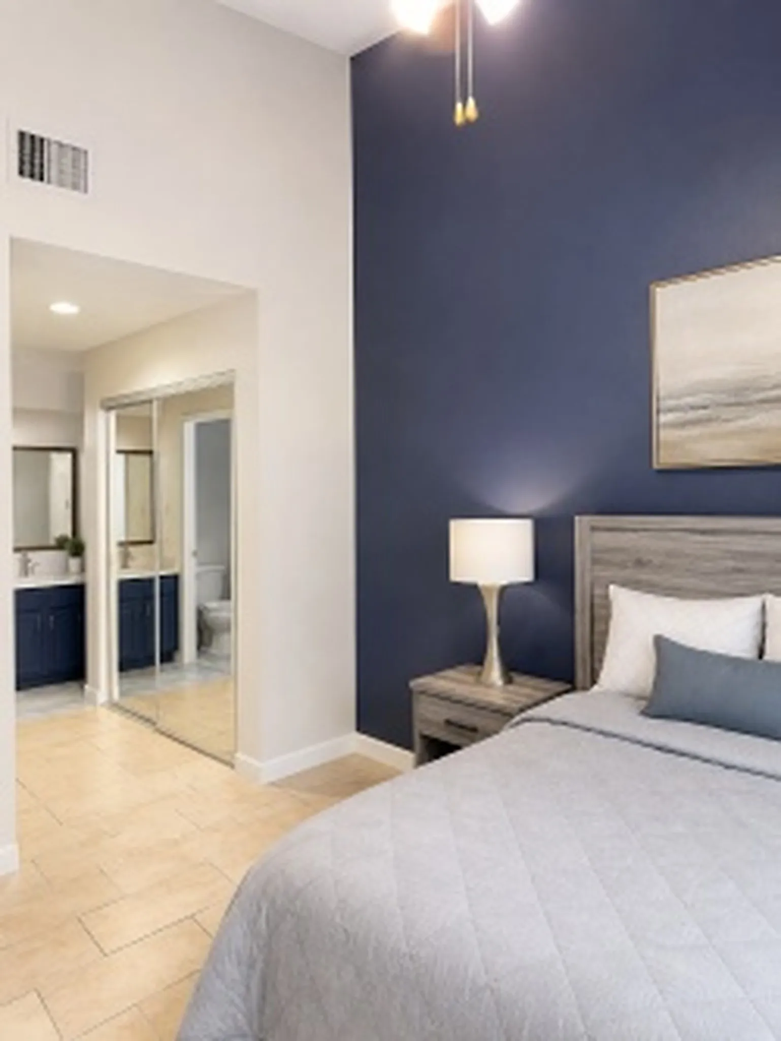 Primary Room - High ceilings with a ceiling fan, accent wall, tile flooring, and mirrored closet doors