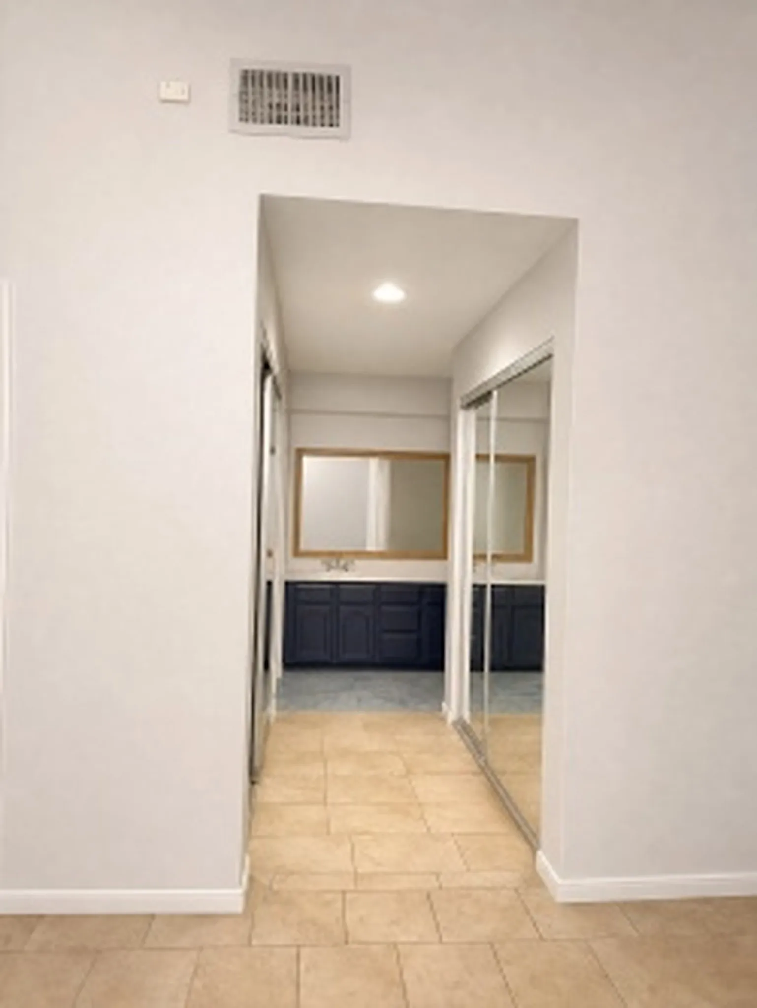 Hallway closets with glass sliding closet doors