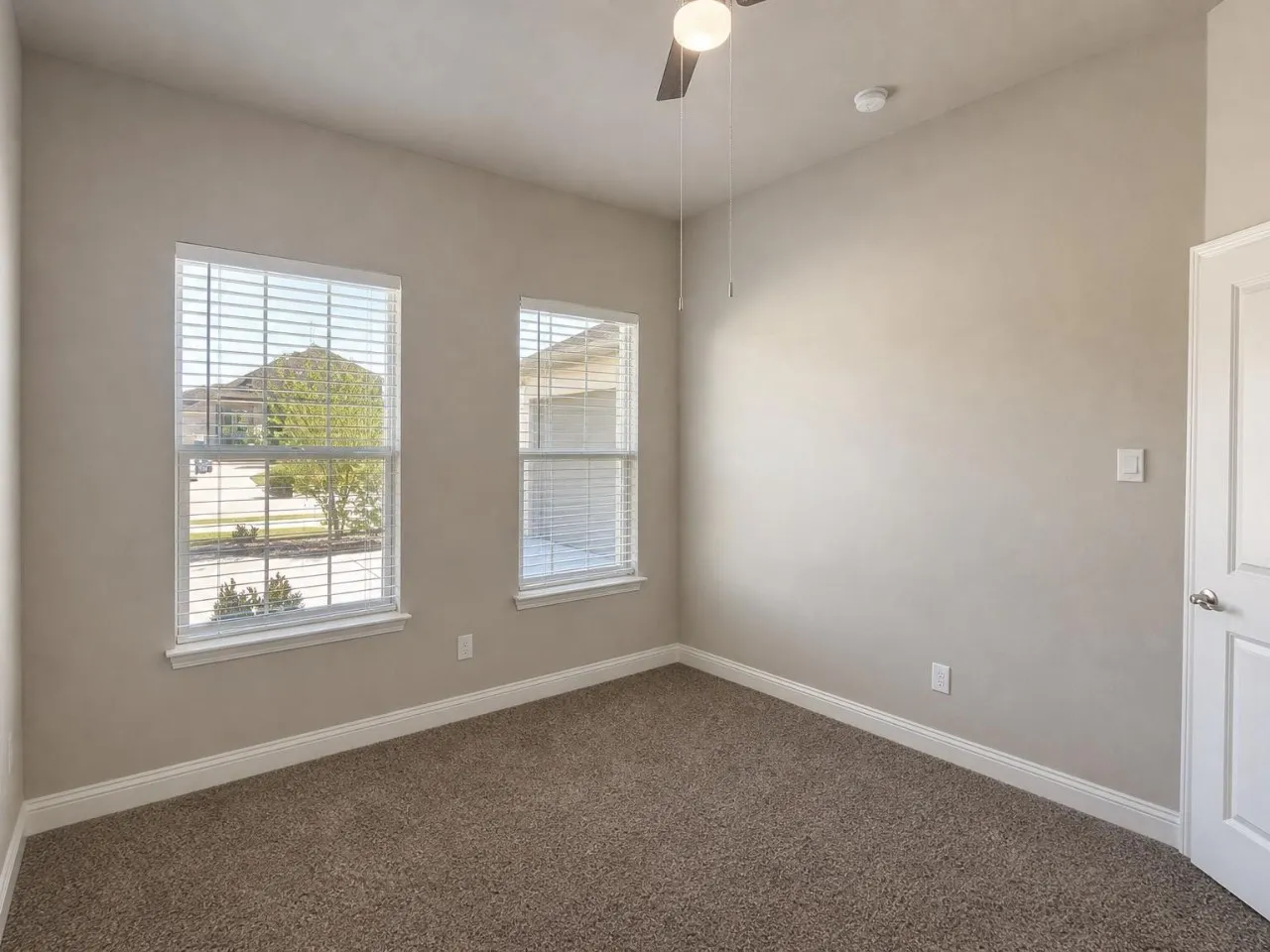 Plush carpeted flooring with light-toned walls