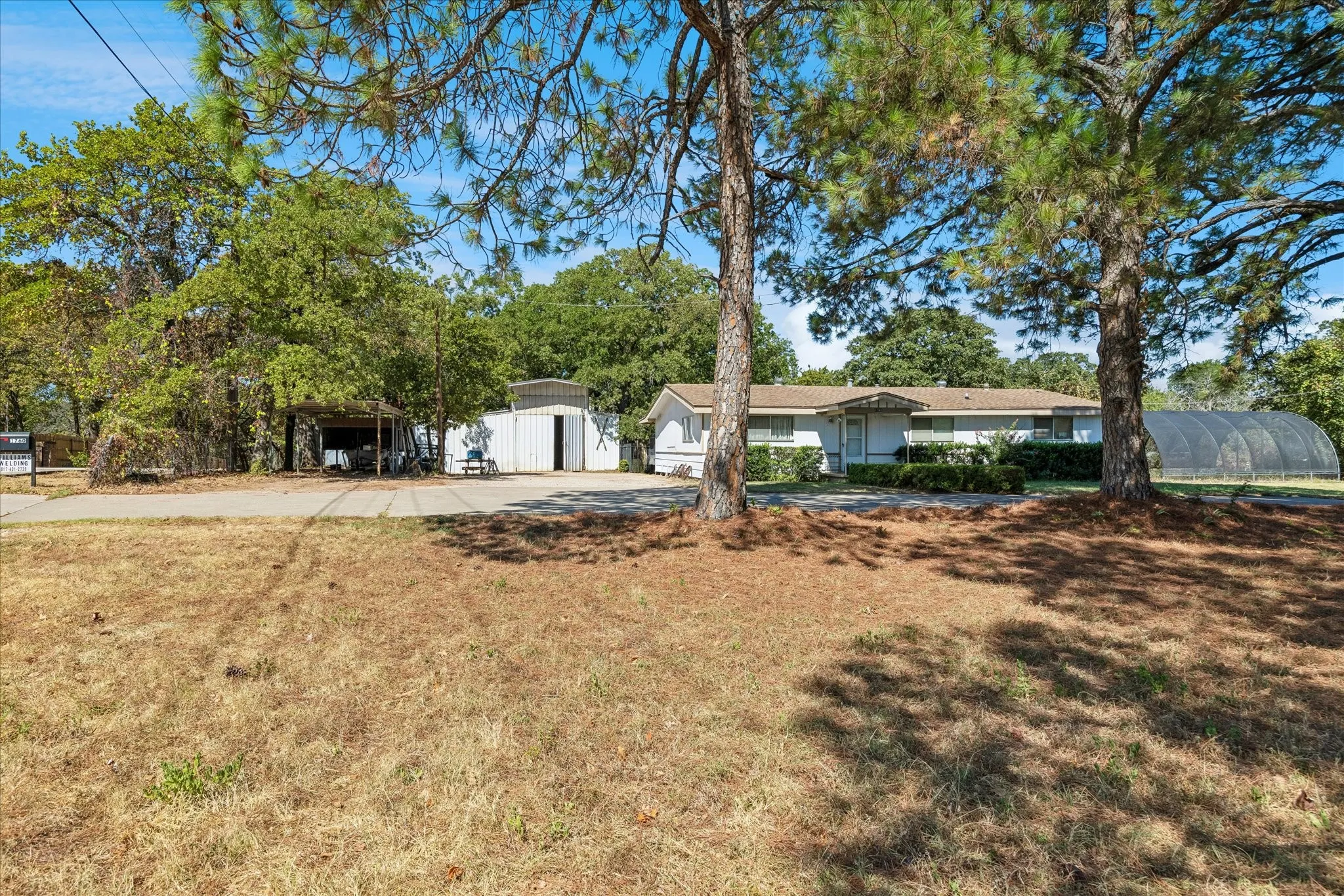 Main house with 1404 sf and 3 bedrooms and 1 bath was built in 1971. House will convey As Is along with large crop tunnel on right side and out buildings on left side.