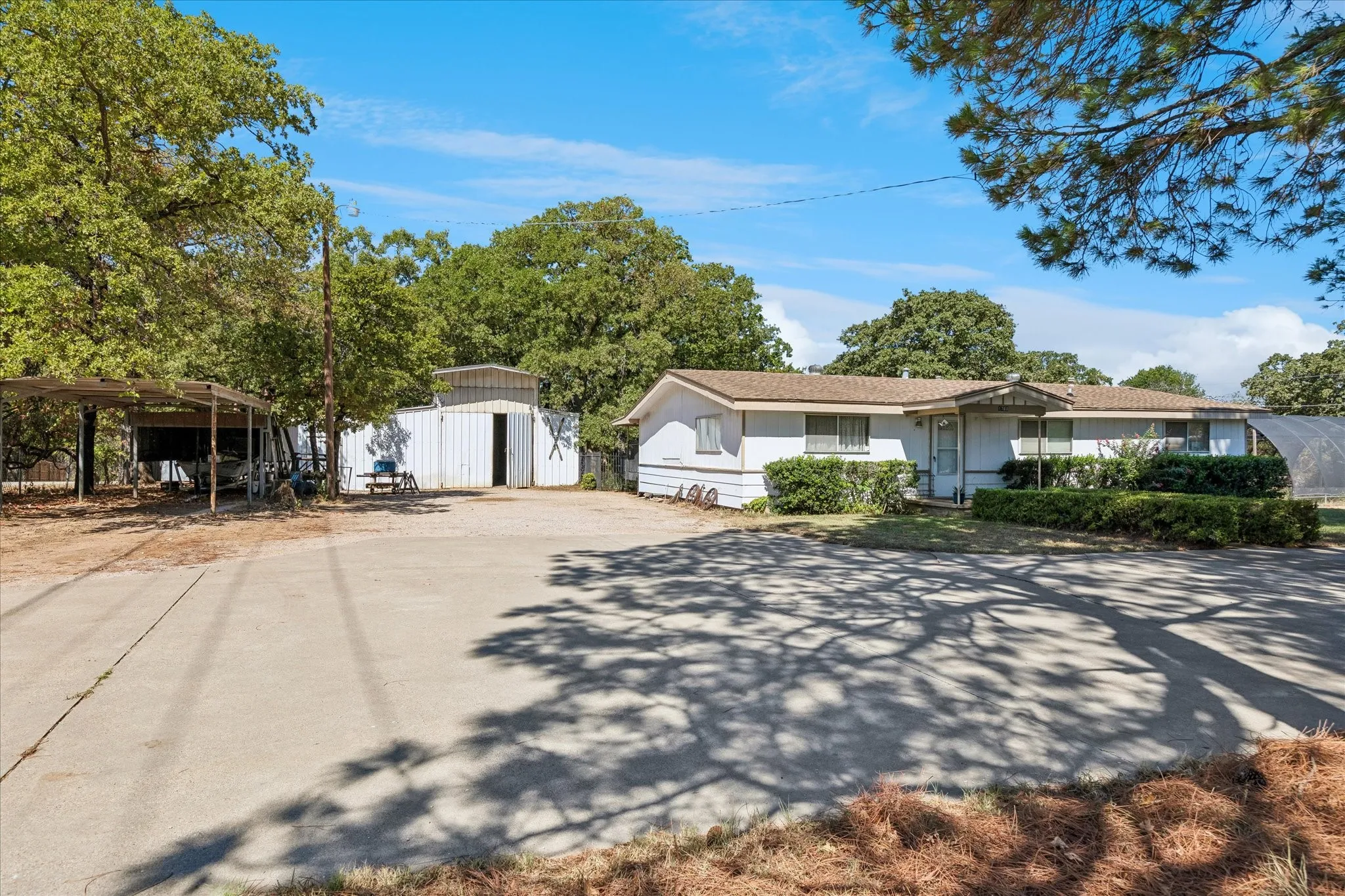 Concrete circular driveway at front of property.