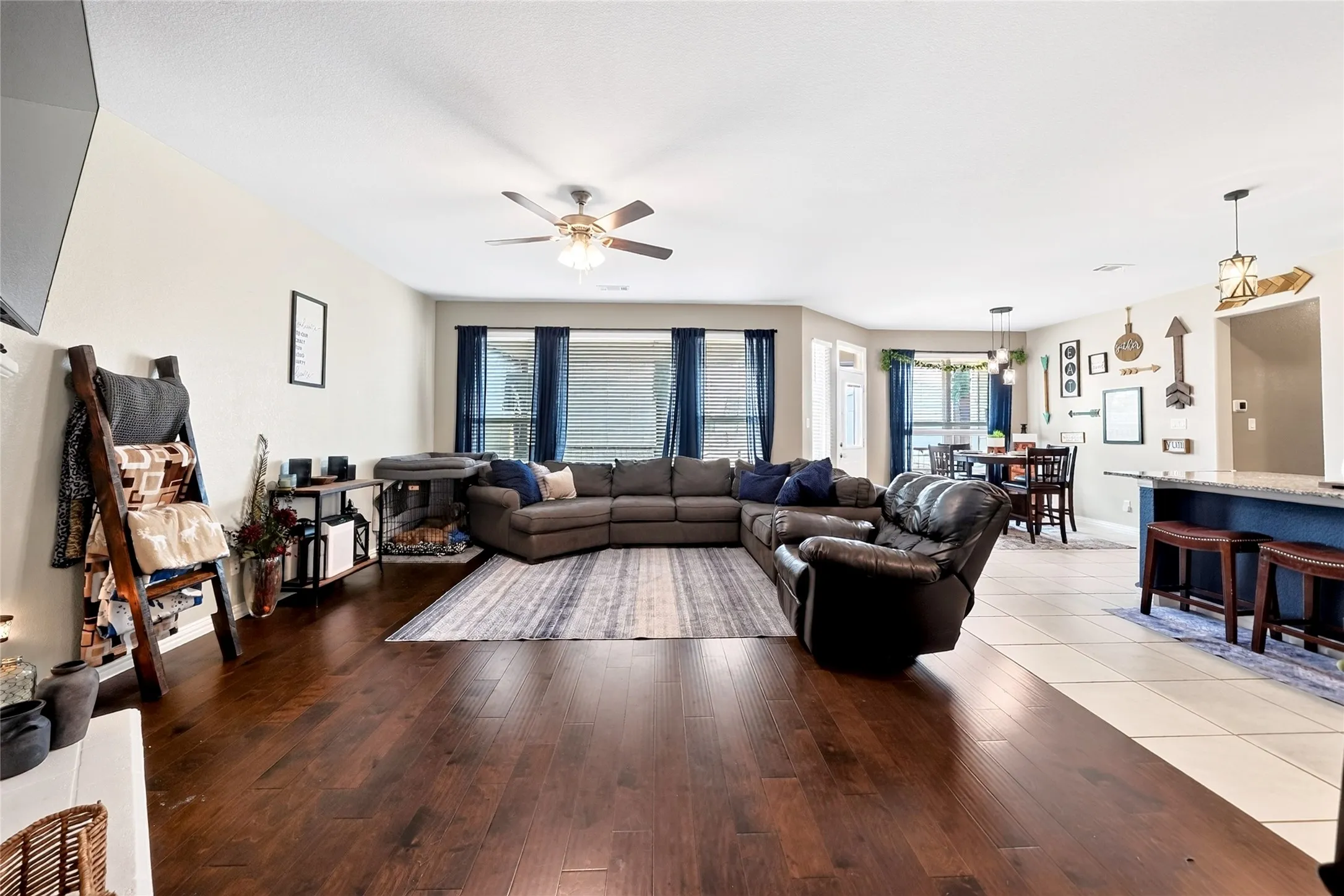 Open-concept living area featuring wood-finish flooring, recessed lighting, and a ceiling fan