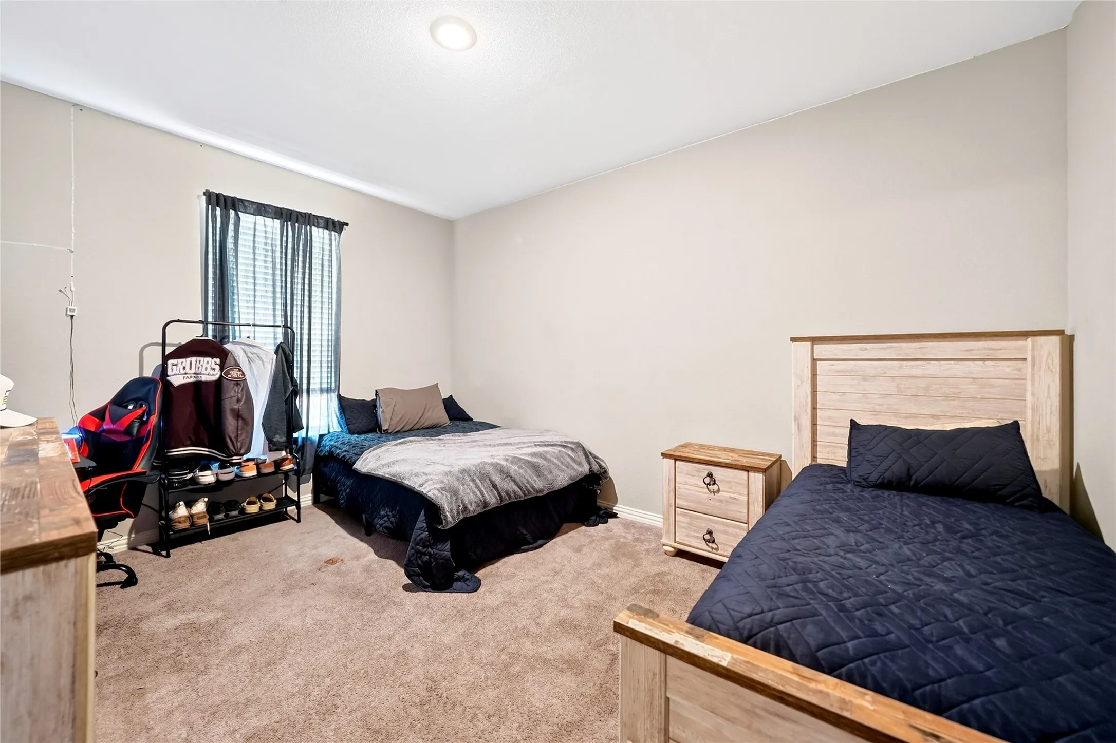 Carpeted flooring, recessed ceiling lighting, window with blinds, and light-toned wall finishes