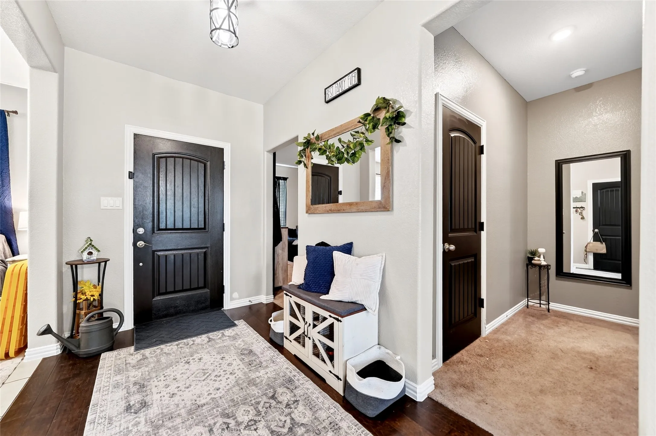 Dark wood-finish flooring, interior doors with vertical paneling, and recessed lighting