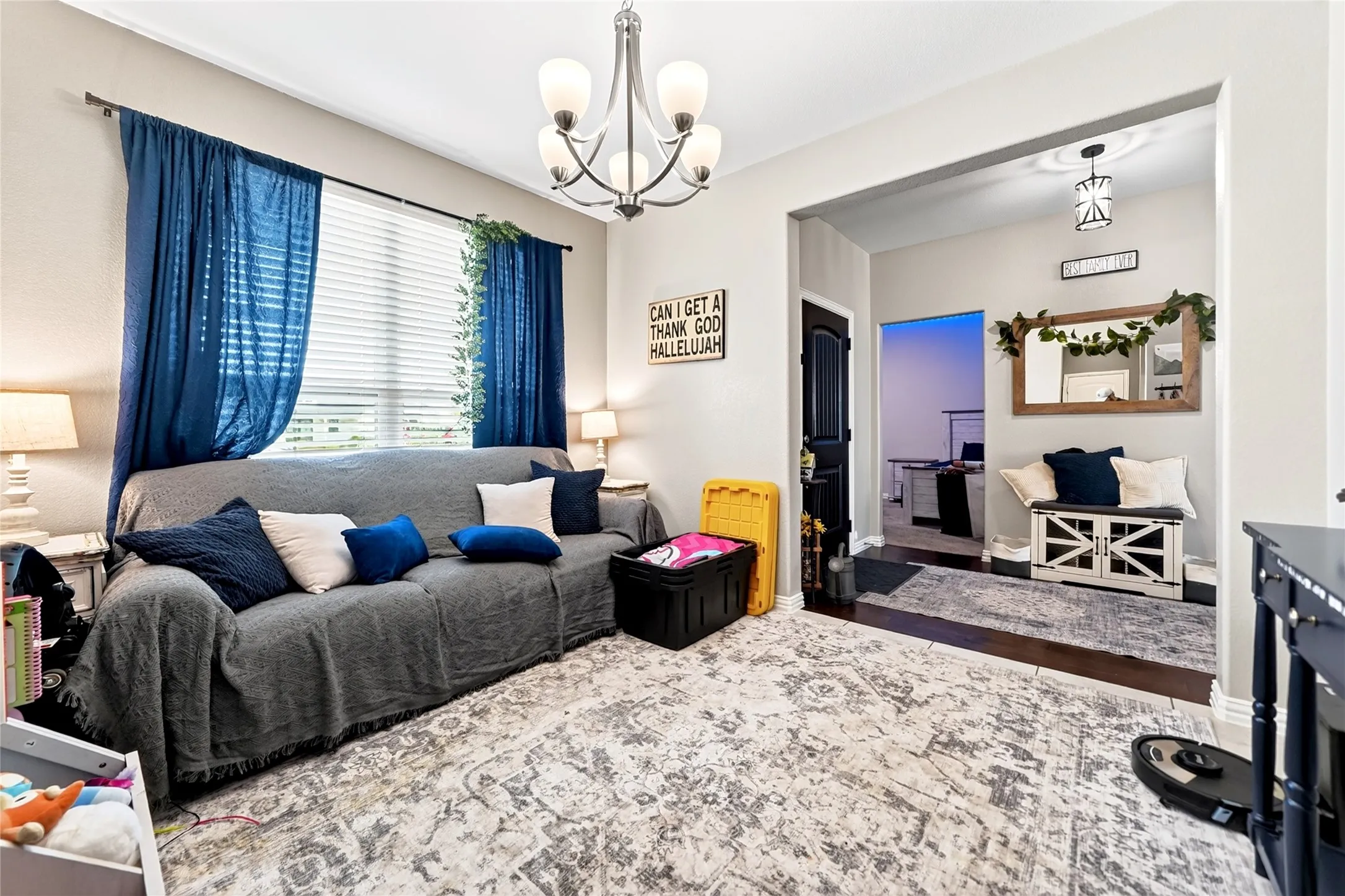 Recessed window with blinds and chandelier lighting