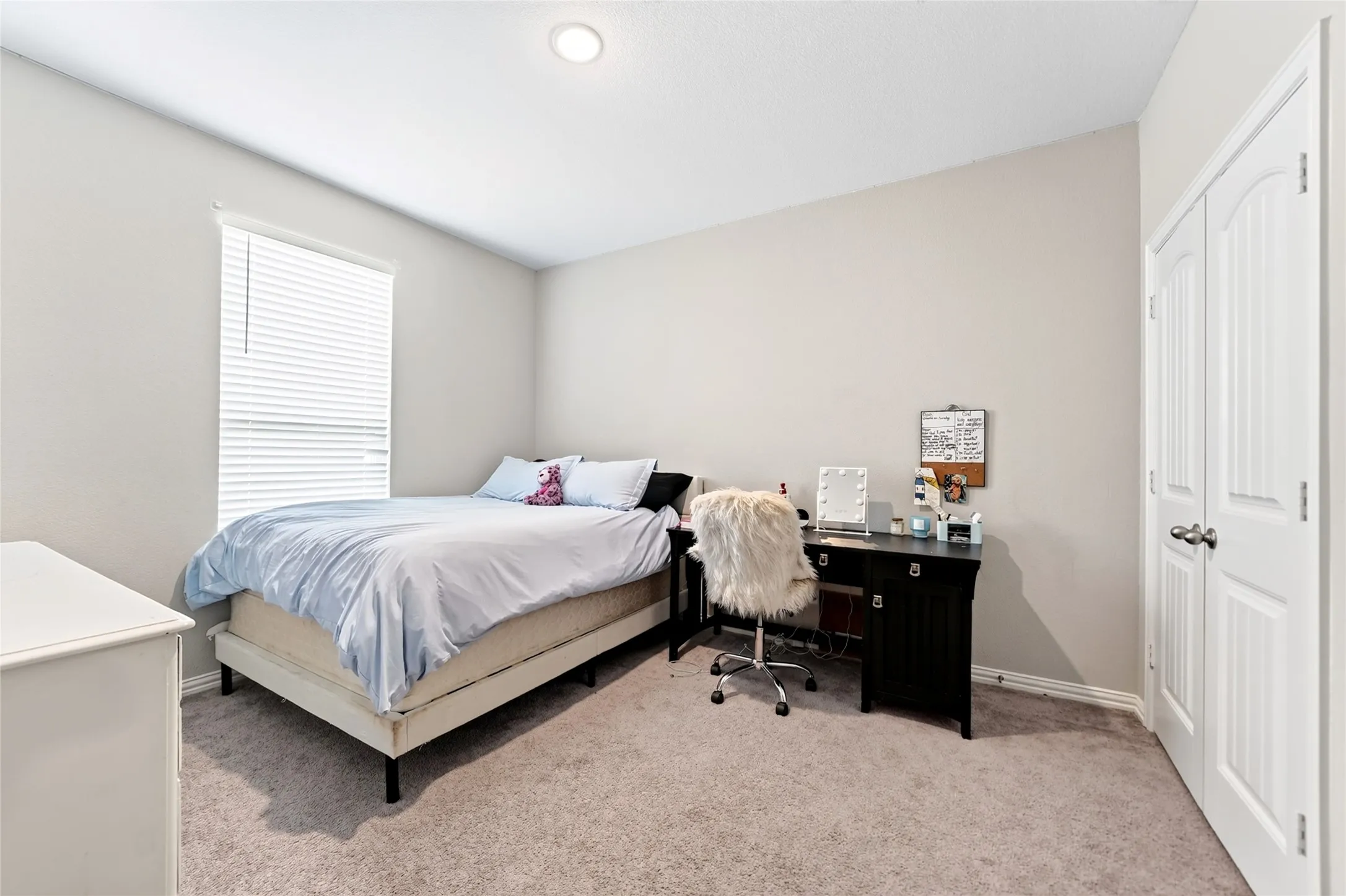 Recessed lighting, window with blinds, light gray wall paint, carpet flooring, and bi-fold panel doors