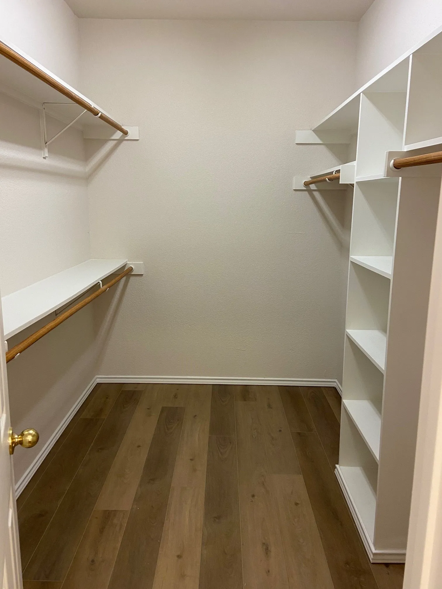 Large walk in master closet with custom shelving.