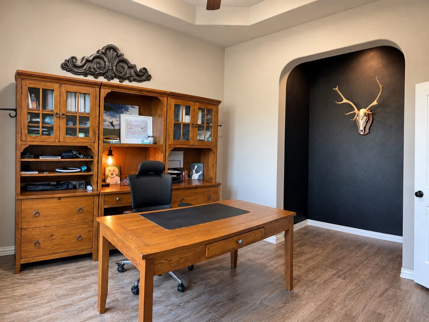 Wood-look flooring, ceiling fan, and tray ceiling
