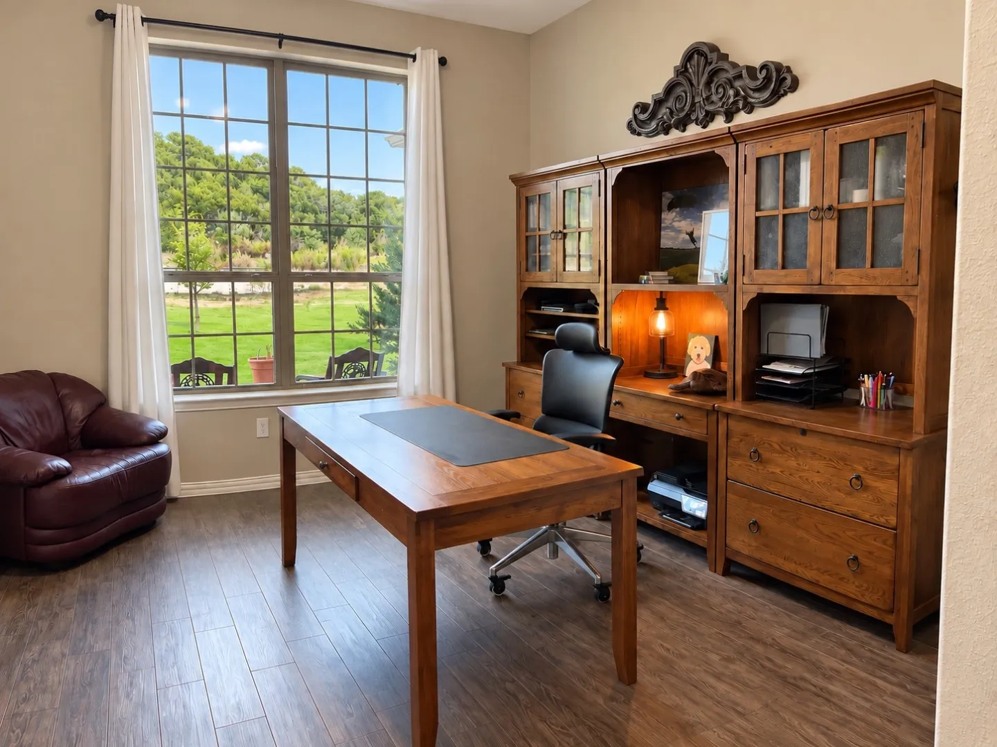 Wood-finish flooring with a large window featuring grid panes