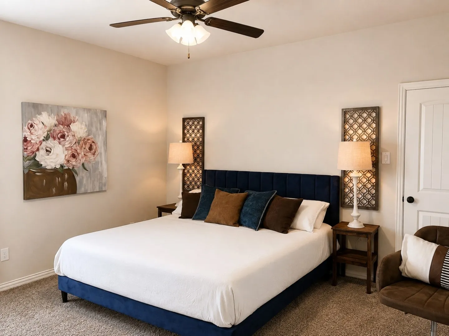 Ceiling fan with integrated lighting, textured wall decor, and a paneled interior door