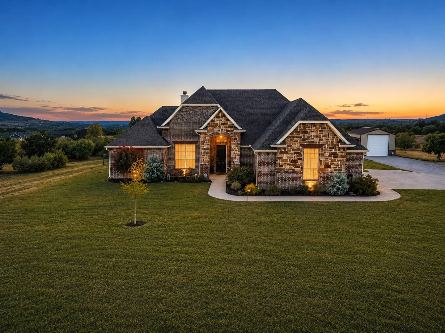 Stone and siding exterior with a dark shingle roof