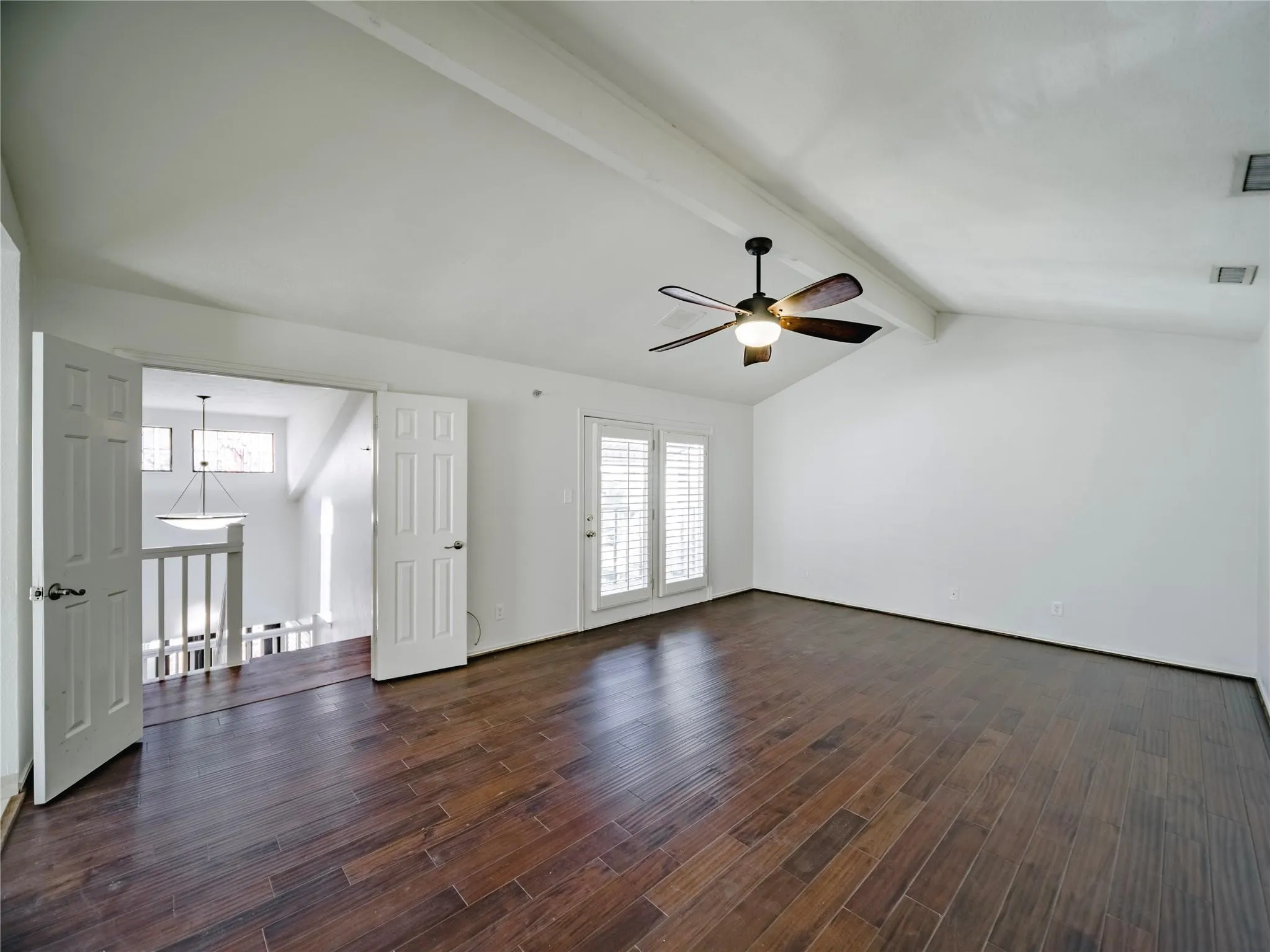 Upstairs primary suite with private access to covered balcony