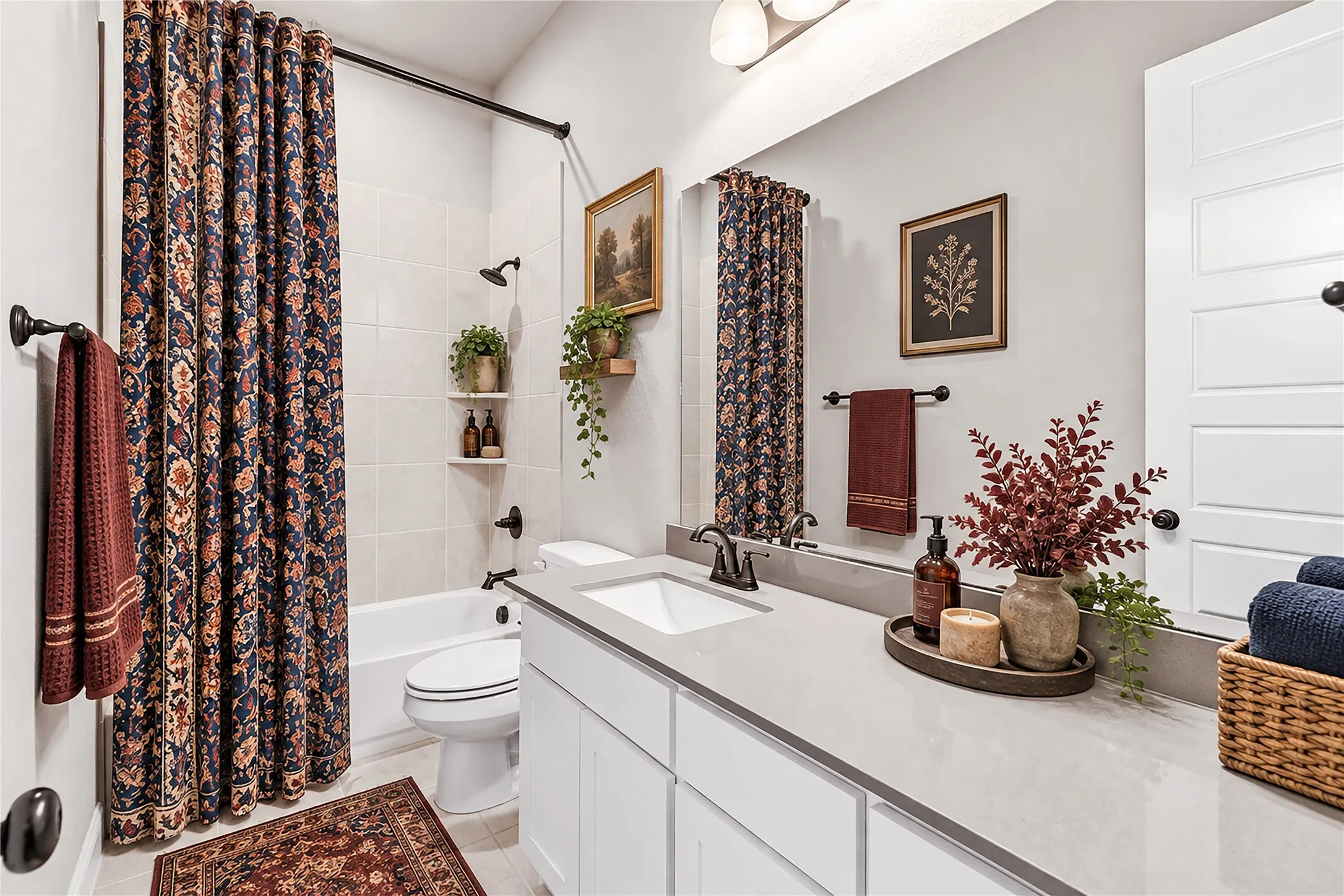 White vanity with a single basin sink and dark bronze fixtures, light-toned countertop, and recessed lighting. Virtual staged.
