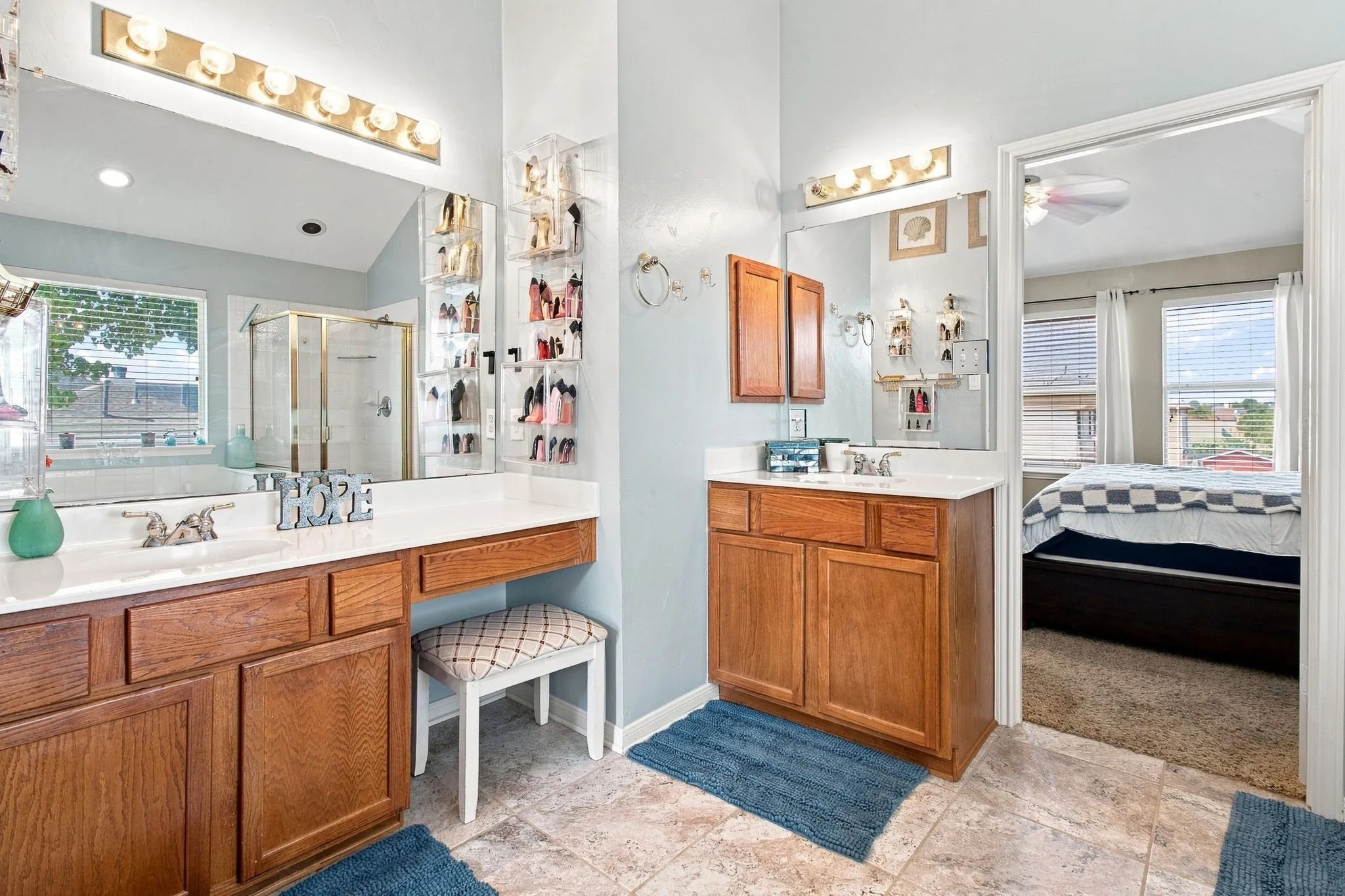 Dual wood-finish vanities with white countertops and undermount sinks