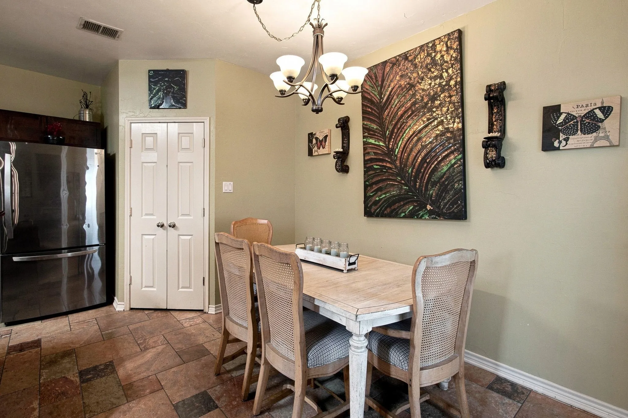 Stone tile flooring, recessed lighting, and a bi-fold door