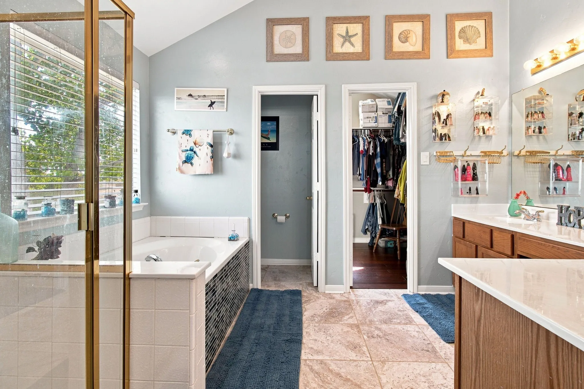 Tiled flooring and a built-in soaking tub with mosaic tile surround