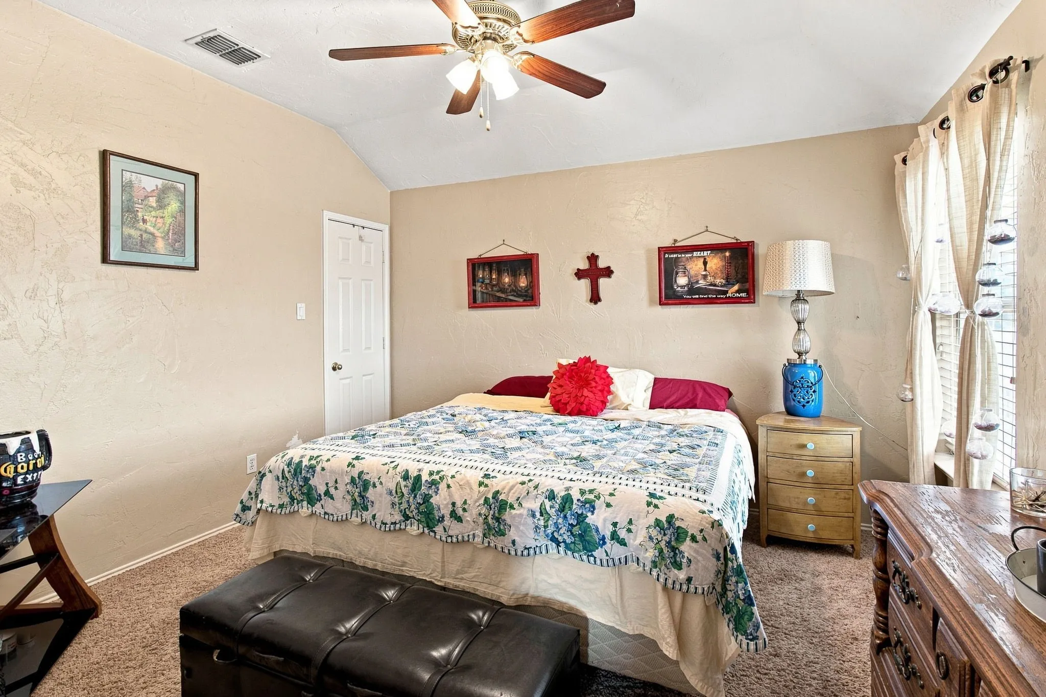 Vaulted ceiling with a ceiling fan, neutral wall tones, and carpeted flooring