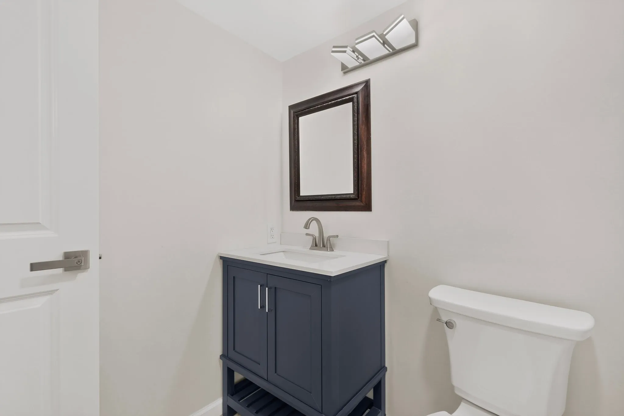 Built-in vanity with a white countertop and undermount sink