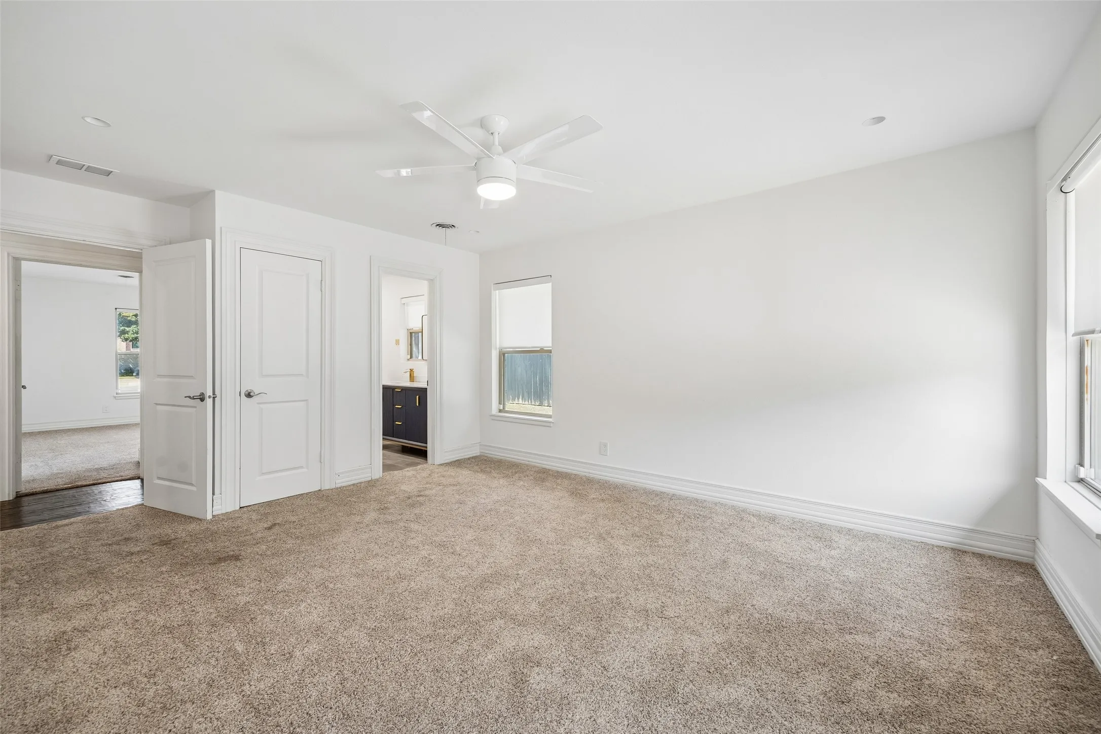 Wall-to-wall carpeting with natural light from multiple windows