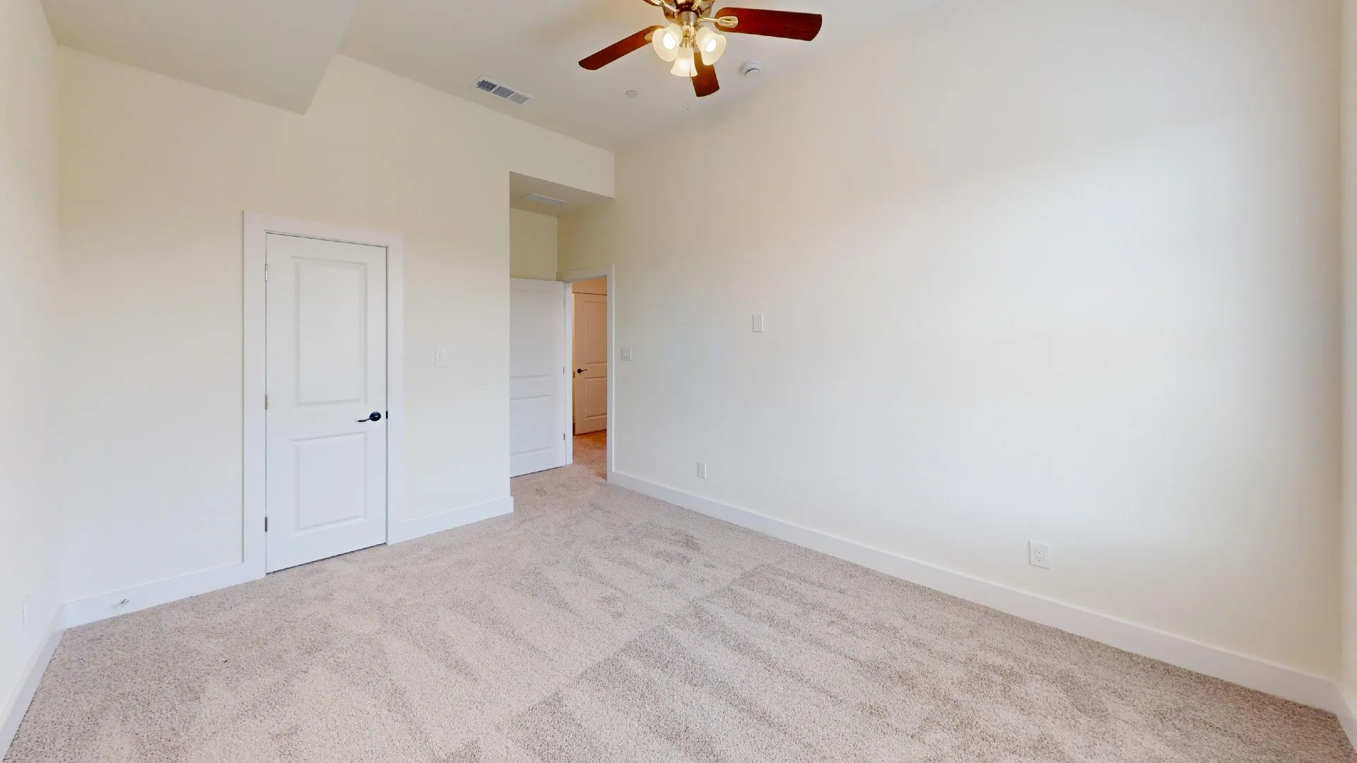 Neutral tone carpet flooring and light-toned walls