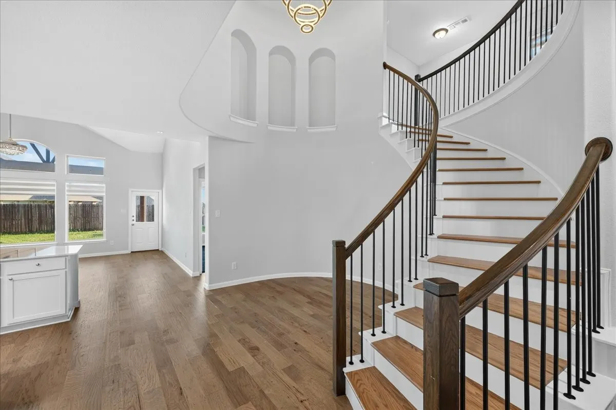 Gracious curved staircase with wood treads and handrail