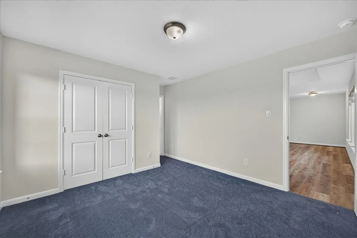 Room with blue carpeting and light gray walls