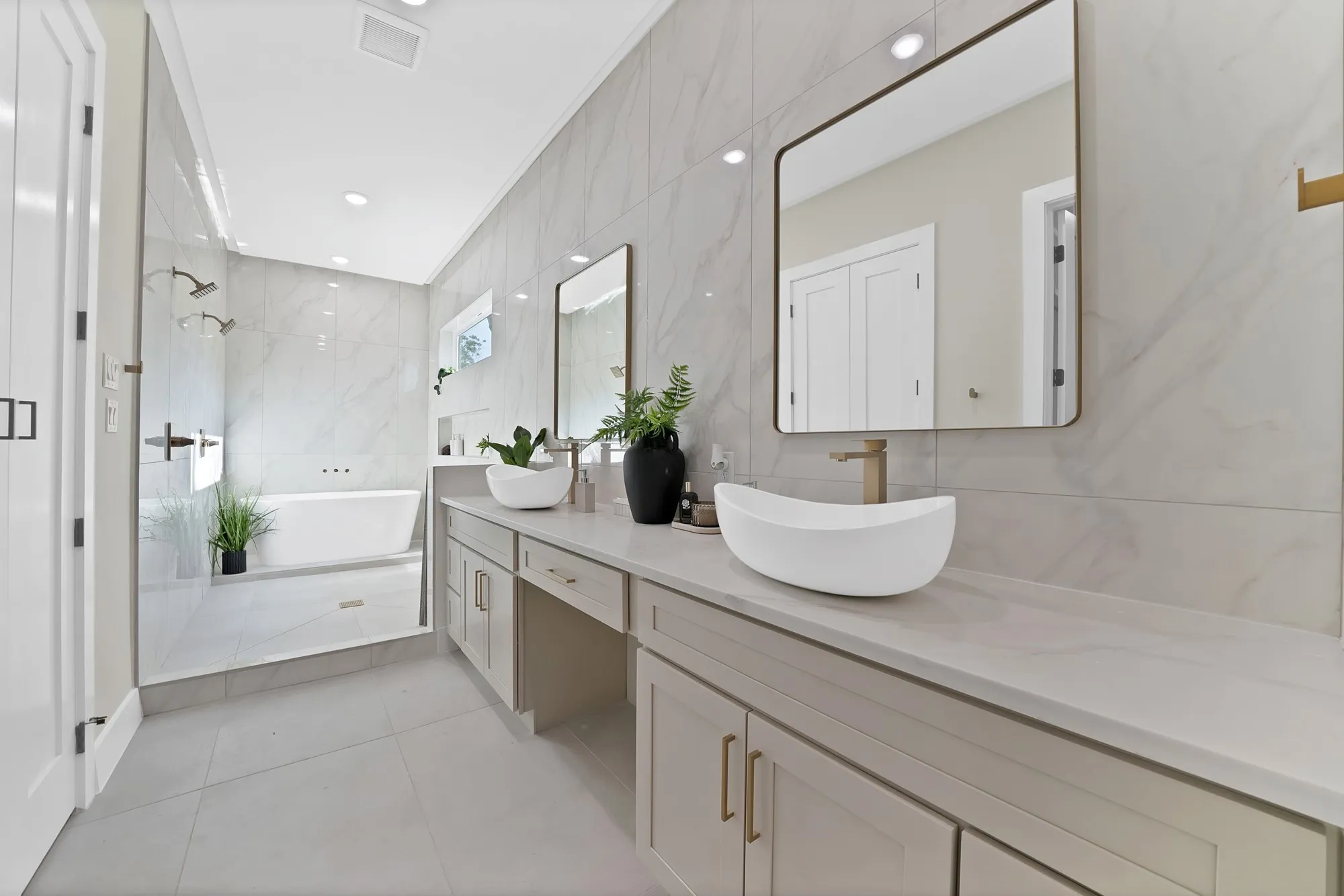Dual vessel sinks with gold-toned faucets
