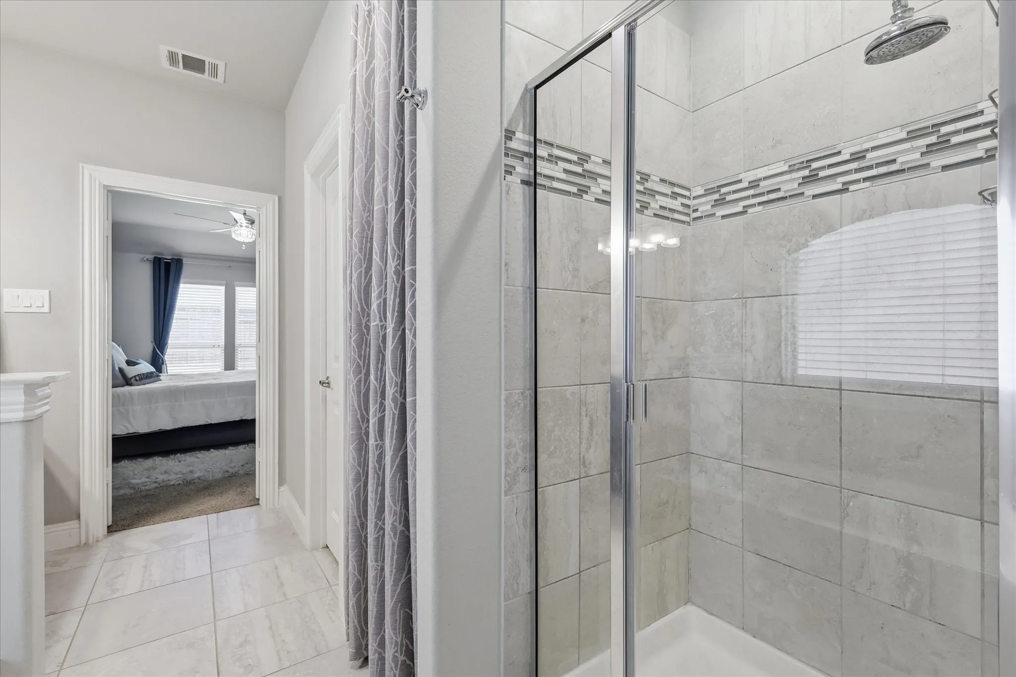 Enjoy a spa-like experience with decorative tile accents and a rain shower