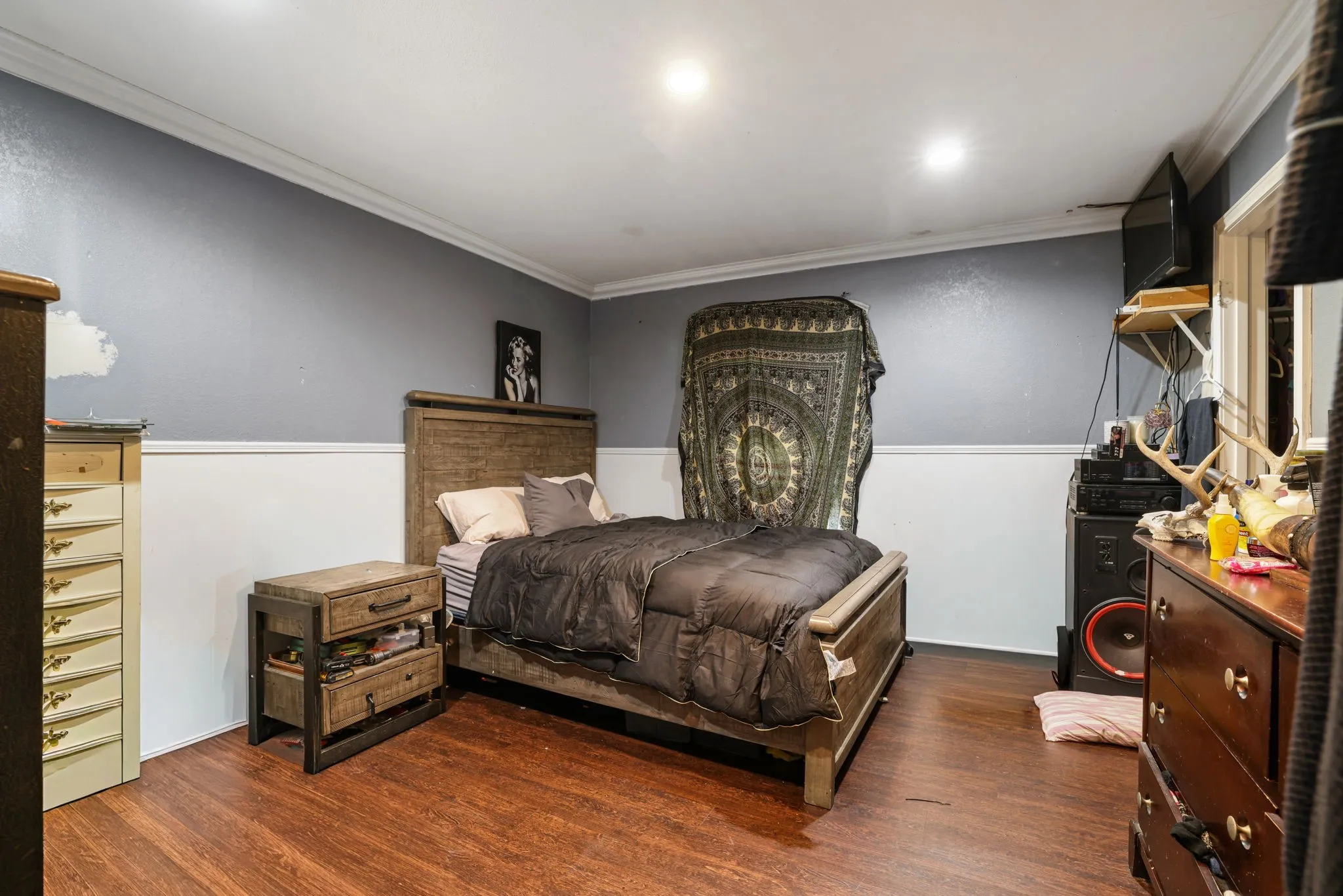 Wood-finish flooring with white wall paneling
