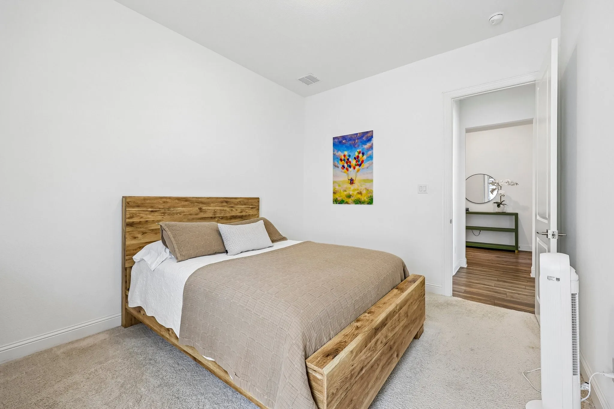 Plush carpet flooring, crisp white walls, and a recessed ceiling light