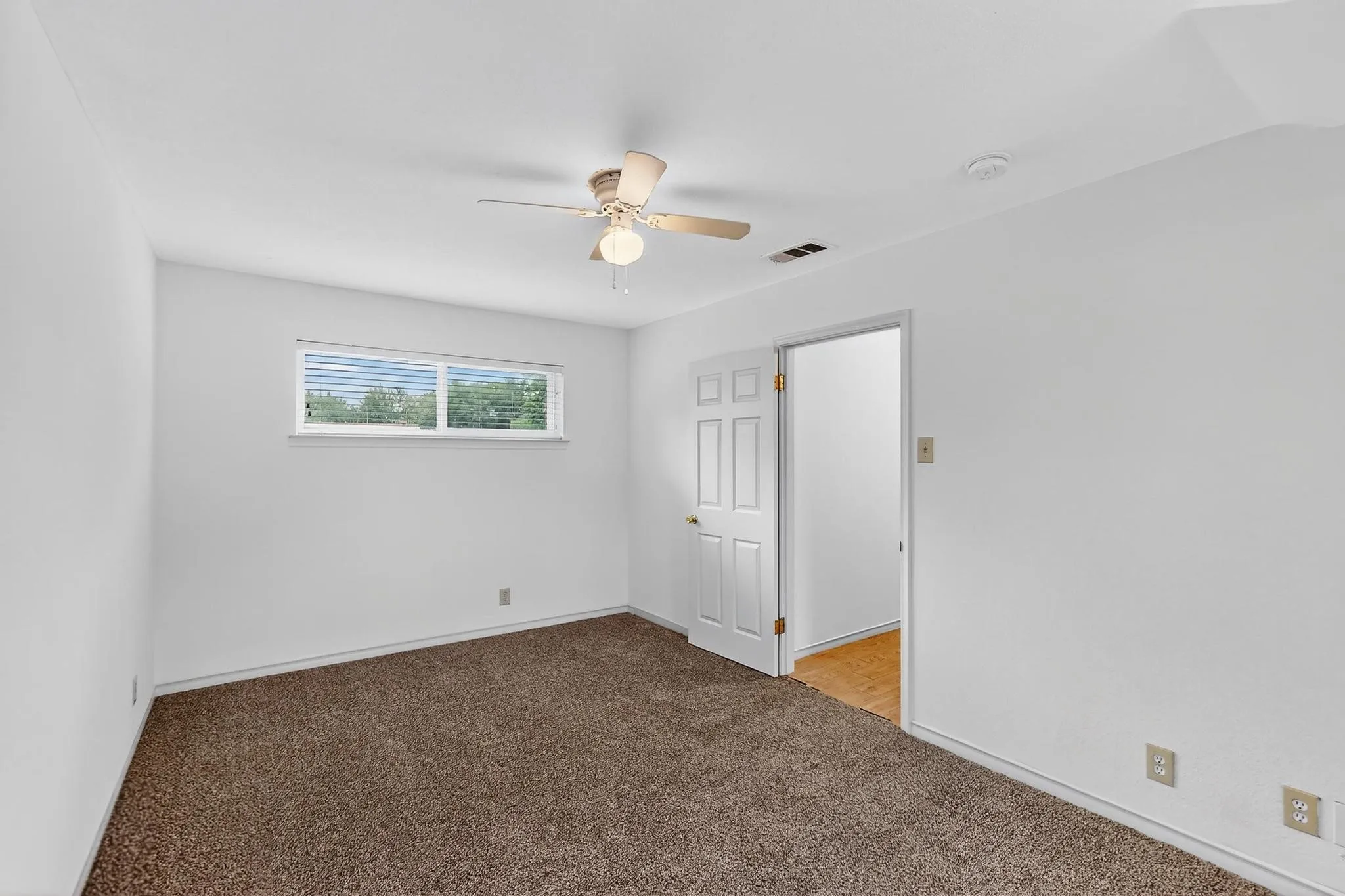Unfurnished bedroom featuring carpet floors and ceiling fan